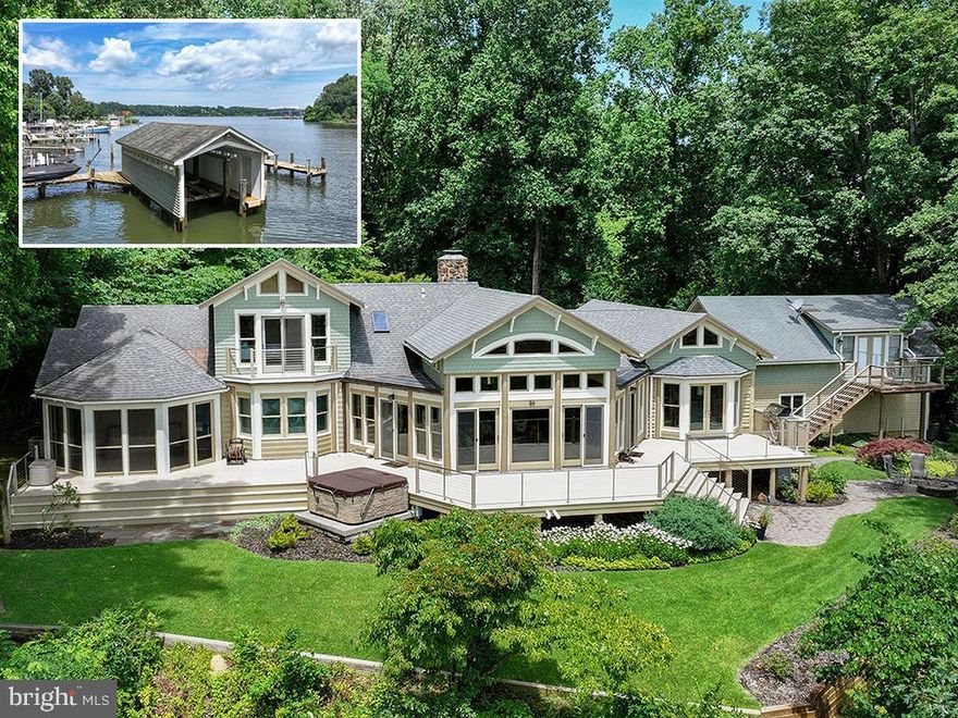 Ideally situated on the banks of Luce Creek with sweeping views down the Severn River, 1715 Porters Hill Road is a unique heritage property with over a century of history. Set on a 1.7 acre lot with 265 ft of waterfrontage, the property includes a large, hard-to-find boathouse that provides both charm and utility for all your waterfront adventures. The private pier has 7+ ft water depth and can accommodate a large vessel as well as an assortment of smaller boats. The tram makes access to the water effortless, and the entire property enjoys an exceptional privacy.
Steeped in its storied past yet thoughtfully updated for modern living, this retreat captures the perfect balance of historic charm and casual elegance. The heart of the home is a sunlit great room with original log walls and quarried stone fireplace, a vaulted ceiling, and expansive windows which frame water views at every turn. An adjoining den, with separate entrance option, is a perfect place to relax. This could easily become another main level bedroom with ensuite bathroom. The kitchen is striking under its vaulted ceiling accented by exposed beams. The custom cabinetry, GE Monogram stainless steel appliances and generous island give the space so much functionality while maintaining the artisanal character. The kitchen opens to the dining area overlooking the water. The table is anchored by a craftsman-style light fixture, and the entire first and second floors have beautiful wood floors. Step outside and you’re embraced by nature: multiple porches and decks overlook lush, manicured grounds that lead down to the water’s edge. 
The main-level primary suite is a true sanctuary, designed for privacy and tranquility. The bedroom, with a vaulted ceiling, has a screened porch overlooking the water. Two expansive walk-in closets offer custom organization systems that would make a clothing connoisseur smile.  The spa-like bathroom gets lots of natural light from the windows that frame the water, and the freestanding soaking tub is situated to enjoy this view. A dual-sink vanity, heated floors, generous walk-in shower with a built-in bench, and a spacious cosmetic area with dedicated seating make getting ready feel effortless and luxurious. A dedicated laundry area just off the hallway makes day-to-day living very easy. Part of the primary suite is a gracious office with gas fireplace and outdoor access. This is a totally flexible space: install a wall of bookshelves and you’d have a lovely library.
Upstairs, there are two generously sized bedrooms. One has water views and a waterside balcony; the other overlooks the lush landscaping out front. There is a hall bathroom.  A separate guest bedroom suite above the garage, complete with its own living area and luxe bathroom, is ideal for visiting friends and family who desire more privacy.  The Historical Context: Originally built in the 1880s, this log house was one of three identical structures used as hunting lodges. It is the only one that remains. The construction of the log house is one of great craftmanship, including sizing each log to be approximately the same diameter as others. Lore has it that around the turn of the 20th century, the Naval academy wanted to acquire more land by the academy and traded this peninsula for land across from College Creek. The Naval Academy superintendent, Admiral David Porter, could be where the name Porter’s Hill derived from. In the 1920’s, the Whitehead family – three brothers known for running bootleg liquor to Baltimore and Washington during Prohibition — used the property as a place to entertain and stop on the way to Baltimore. In the 1940s, the brothers’ exploits caught up with them, and the State of Maryland confiscated the Porters Hill peninsula. Through a unique trade involving the Jones family’s gravel pit (now the site of the 895 Tunnel), this private waterfront enclave found its next chapter.