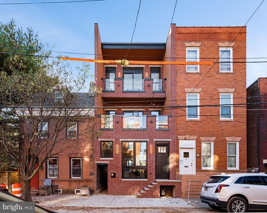 Presenting 1124 Marlborough Street, the epitome of modern luxury living.  This is a one of a kind,  meticulously crafted, new construction, 3-bedroom and 4.5-bathroom home with two spacious balconies, two breathtaking rooftop decks, and an expansive backyard. This property offers an unparalleled blend of sophistication and comfort, making it the perfect home for those who demand the very best. Step inside and you will notice just how expansive the property is, sitting at 19ft wide with 10ft ceiling height. The white oak hardwood floors reflect the sunlight coming in from all angles of the home, giving a warm welcome to everyone who enters.  Walking to the back of the first floor you can't miss the one of a kind floating raw edge elm wood stairs matched with sleek custom iron railing. The kitchen was thoughtfully designed by Craftsmill Cabinetry and includes a top-notch appliance package from Thermador. The flexible floor plan allows you to take your dinner party outside to the sizable compost wood decking patio and then back down into the finished lower-level living area. The second floor is complete with two large bedrooms that each have ensuite bathrooms, an expansive balcony perfect for a morning cup of coffee,  and a conveniently located laundry facility. The primary suite, occupying the eastern wing of the house, is a true masterpiece with a custom built in closet system, 12ft ceilings, another well designed modern balcony, and a lavish en suite bathroom featuring a six-way shower, double sinked vanity, LED mirror, and a gorgeous freestanding bath. The property is then complete with two jaw dropping roof decks, one that has remarkable views of the city skyline and the other that gives you a great view of the iconic Ben Franklin bridge. Never worry about internet connection as the property has been equipped with a commercial grade WiFi system. This property is truly one of a kind, outfitted with tasteful finishes and thoughtful floor plan design.