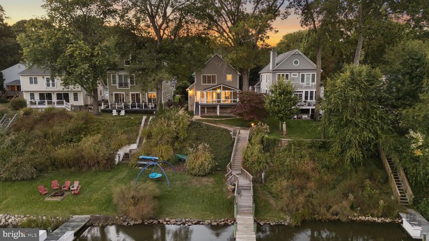 Waterfront living at its finest in newly renovated and updated home on Deep Creek with easy access to the Magothy River, Chesapeake Bay, and downtown Annapolis!  Unique location where you can kayak, paddle-board, or canoe to protected nature preserve, use a power boat or sailboat to explore the Magothy, Bay, and surrounding areas, and walk or take any boat option to Donnelly's Dockside restaurant.  Besides a prime location tucked away on a quiet street with convenient commutes to Annapolis, Baltimore, and DC in the Broadneck school district, nothing has been overlooked with this home offering the perfect combination of comfort, style, and natural waterfront living.  From the moment you drive onto the property, it feels like a luxury retreat immersed in nature with the street-side yard including a pond of bullfrog residents and occasional duck visitors, water side yards and pier, and well-designed window placement throughout the house allowing natural light and views of trees, sky, water, and flying and swimming creatures like bald eagles, osprey, ducks, seagulls, songbirds, muskrats, and the occasional otter.  This home is tastefully updated and remodeled throughout with exquisite, top-of-the-line custom finishes and thoughtful design details like hardwood flooring and waterfront views from nearly every room.  Loads of windows, all season sunroom, and atrium doors across the front fill the home with natural light all day long!  Custom painted throughout with neutral, coastal tones, every detail of this home’s remodeling has been thoughtfully considered from the kitchen rebuilt in 2024 to the new steps leading down the hill to the new pier, bulkhead, and boat lift in 2016/2017.  Even dredging was done in the creek and spur under the boat lift to ensure easy boating access.  The beautifully landscaped yards include children’s amenities—a clubhouse, swings, and basketball hoop—and the stylish concrete and brick-designed driveway provides ample parking leading directly to the attached two-car garage.  Additional highlights include electricity and plumbing at the pier featuring a solar-sensor pier light that can be operated from inside and outside the home, a new roof (including sunroom) in 2016, new BAT septic system in 2024 (which was moved street-side to allow water-side hardscaping options), french drains in water-side yard (2018), drains added to driveway to redirect run off (2016), re-pipe and upgrade of all plumbing pipes to code (2024), EV charger in garage (2019), all new flooring (2024), and upgraded water treatment system to accommodate lawn irrigation (2019).  All of this and more to ensure low-maintenance living.  With voluntary membership in the Shore Acres Improvement Association, you can enjoy and walk to community events and amenities like the playground, clubhouse, and Magothy River beach, boat ramp, and recreation area.  This home offers the perfect combination of comfort, style, and true waterfront living immersed in nature and with access to all water activities.