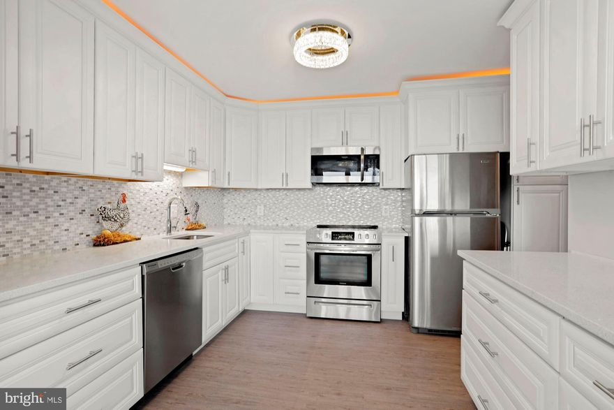 Rarely available and designer-inspired, come enjoy this completely remodeled 2 bedroom, 2 bath condo with over $100,000 in improvements including an open and enlarged gourmet white kitchen with stainless steel appliances,  white quartz counter-tops and mother of pearl back-splash. Open and light-filled layout with the kitchen opening to the dining room and living room. Additional updates include decorator lighting, designer flooring, beautiful marble bathrooms  (one with shower and one with bubble tub), fresh paint and newer windows. Spectacular sunset views of Tyson's and the Virginia and Maryland countrysides from the private balcony. McLean House is so special because the condo fee includes all utilities. Pay for only internet and television. Walk to shops and restaurants, plus there are two beauty salons in the building! Great location just minutes to D.C., Tyson's and Dulles. GARAGE SPACE WAS PURCHASED FOR $20,000 AFTER SELLER PURCHASED UNIT.  SELLER HAS DEED SHOWING DATE OF PURCHASE FOR GARAGE SPACE. TOTAL ORIGINAL COST FOR THE UNIT AND GARAGE SPACE IS $330,000.  SELLER THEN SPENT APPROXIMATELY  $100,000 ON UPGRADES.