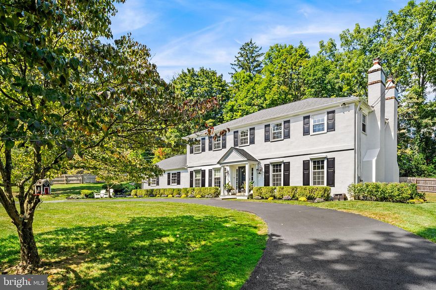 Walk to Wayne from this beautifully renovated classic colonial perched on a sprawling corner lot with an attached two-car garage and over $450,000 in upgrades and improvements! A repaved circular driveway leads to the covered front porch. Step inside and marvel at the seamless, open floor plan with hardwood floors, designer lighting and custom moldings throughout, part of a major renovation undertaken by the current owners to update the home’s flow. Just off the entryway sits a large sunken family room that boasts space for separate gathering and entertaining areas, along with a wood-burning fireplace flanked by custom built-ins and cabinetry and glass sliders leading to the rear patio. On the other side of the main level you’ll find a sparkling white kitchen with high-end appliances—including a Sub-Zero® refrigerator and Wolf® range—and a generously sized island with ample seating. The kitchen opens directly to a light-filled dining room with views of the gently sloping front yard. Off the kitchen you’ll find a renovated mudroom with custom cubbies and bench seating plus a wine fridge and counter area. The mudroom also connects to the two-car garage and features a separate French door for easy access to the rear patio. An open staircase leads to the second floor, where you’ll find hardwood floors throughout and a dreamy master suite with a newly renovated and expanded en suite bath and custom walk-in closet. Renovated in spring 2023, the master bath boasts dual vanities, a water closet and oversize shower with rain shower head and frameless glass door. The bath connects via pocket door to a walk-in closet with custom floor-to-ceiling cabinetry and shelving. Down the hall are three well-sized bedrooms, a full hallway bath and a laundry closet with custom barn door. More space awaits in the finished lower level, which features a separate room ideal for a home office or gym, plus two open areas for entertaining and play, custom built-ins and plentiful storage. Outside, the private, fenced backyard features a high-end bluestone patio that runs the entire width of the home, plus a wood-burning firepit with retaining wall/seating, a new hot tub with custom stone enclosure and a maintenance-free pergola with built-in electric. The exterior has been professionally landscaped with flowers and shrubs timed to bloom with the seasons, and the side yard offers plenty of open greenspace. Located on one of the most beautiful streets in Wayne, this home is within walking distance to two train stations, award-winning Radnor schools and abundant shopping and dining.    Please see list of improvements available in Documents. Sellers had stucco test completed in 2020 with no issues; see report available in Documents. Make plans to tour this Main Line gem today!