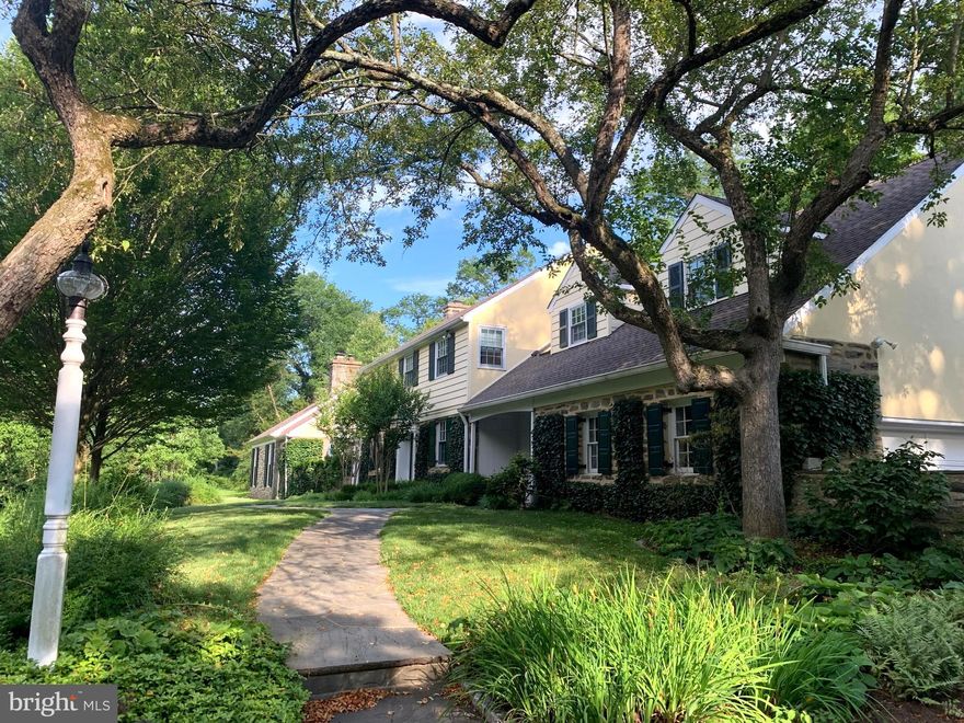 Spectacular property to enjoy nature and tranquility with over one acre of mature plantings and perennial gardens just a short walk to Forbidden Drive and the Wissahickon trails located in Springfield Township, just beyond the border of Chestnut Hill. The colonial home, built in 1959, is a manageable size with five bedrooms and three and a half baths and has just under 4,000 square feet of living space. Enter the home through the front entry hall and the first floor includes a charming den with wood paneling and bookshelves, family room with beamed ceiling, fireplace, wet bar with built-in refrigerator and cabinetry and sliders to the deck and beautiful pond and fenced garden.  The living room has a with fireplace, recessed lighting and French doors to the outside flagstone patio, dining room with chair rail, a powder room, a full bath and a cheerful eat-in kitchen with breakfast nook with access to the laundry room, back yard and to the two car attached garage. Upstairs are five good sized bedrooms including the master bedroom with two walk in closets, master bath with radiant heat and a hall bath.  This home is set in the most peaceful location yet offers exceptional access to the wonderful amenities of Chestnut Hill and easy access to center city Philadelphia and all major highways.Remarks:  Separate lot with separate parcel number 52-00-17398-505 on Thomas Road.   Taxes $2,732, lot size: .62.    Total property taxes for acreage of 1.67 is $16,248. On site septic serviced annually ( by George Allen.)  Construction stone, stucco and clapboard with steel beam. Living Room floors, American Walnut.   Seven day generator with propane gas serviced annually (by Amerigas used when necessary.)  Double insulation in ceiling of garage and under wall to wall carpeting with double padding.  Water softener for hot water.  Irrigation system in back garden.  Drainage system in place for back garden.  Speciman planting throughout.  Surrounded in North and West by a conservation.   Total privacy.