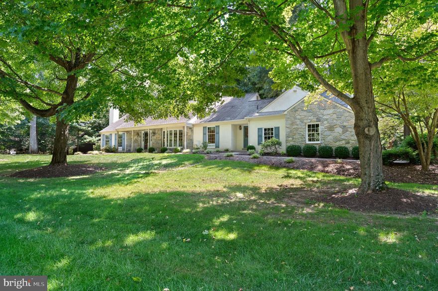 NEW PRICE!  This exceptional custom-built stone and stucco Cape is located in the highly desirable community of Spring Meadows within the Unionville-Chadds Ford School District. The property has been meticulously maintained by its original owners and features a stunning two-story timber frame great room that opens seamlessly to the kitchen and family room, complete with a stone fireplace, making it ideal for gatherings and entertaining. Nestled on 1.7 acres, this four-bedroom, three-and-a-half-bath residence boasts beautiful hardwood floors, stone and brick fireplaces, exposed beams, and timber frame trusses. Upon entering, you are greeted by a two-story foyer that showcases hardwood flooring and abundant natural light, providing access to various first-floor rooms. The living room transitions effortlessly into the formal dining area, which then flows into the expansive kitchen equipped with wood cabinetry and a large island overlooking the great room. The great room features timber frame trusses, skylights, and a wall of windows that enhance the natural light and offer views of the deck and fenced yard. To the left upon entry, an office study includes a fireplace and built-in shelves, creating a comfortable space for work. The main floor primary bedroom includes an ensuite bath and a large window that overlooks the deck and surrounding woodlands. The first floor is completed by a laundry room and a half bath. A gracefully curved staircase leads to the second floor, which accommodates three additional bedrooms, one of which includes an ensuite bath. The lower level is partially finished, featuring a recreational or game room along with a spacious storage area. Additionally, a detached timber frame garage/barn provides an upper level that is well-suited for a home office or an entertainment venue. This building has its own driveway with extra parking. This location offers convenient access to major routes, West Chester, Kennett, Longwood Gardens, and nearby shopping and dining options.