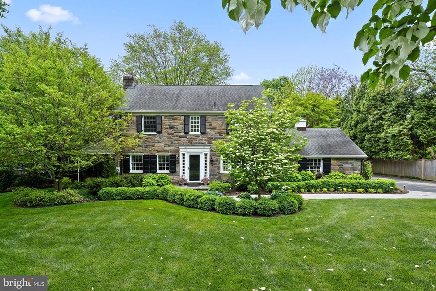 Prepare to be wowed.  This quintessential Main Line Stone Colonial, set on a level approximately 1.3 acre lot is surrounded by mature landscaping and beautiful gardens, located in the coveted estate Section of Haverford near Merion Golf Club. This 4/5 Bedroom 3.5 Bath home has been meticulously updated and is truly a private respite from it all, both inside and out. A stunning courtyard framed with fruit trees, grape vines and a unique green roof welcomes you onto the entry veranda. The gracious foyer opens into the expansive family room & breakfast room with a stunning gas fireplace and stone surround, recessed lighting, a wall of windows and French doors opening onto a delightful covered porch and deck perfect for relaxing and enjoying the manicured yard. The newly renovated designer kitchen with Thermador appliances, 6 burner gas range, professional hood, granite counters and tile backsplash is open to the family room. A Mudroom with custom built-in storage bench, coat rack, cabinetry & laundry room with direct garage access is also conveniently located off of the side foyer. The formal dining room with a fireplace, custom built-in bookshelves and access to a covered bluestone patio makes entertaining seamless. The living room is currently being utilized as a quiet study tucked away from the hub of the home. A fabulous layout for entertaining with all rooms radiating from the kitchen and multiple access points from indoor to outdoor living spaces. Beautiful refinished oak hardwoods span throughout the home, and a powder room completes this level.  Upstairs the expanded primary suite has two custom built walk-in closets, a practical shared laundry chute and Juliet balcony for taking in the private, manicured and quiet backyard. The Primary bath features custom tile detail, skylight and frameless glass walk-in shower with built-in shelves. There are three additional spacious bedrooms with ample closet space as well as a 5th bedroom/den which overlooks the courtyard and has views of the flowering green roof. The en-suite bedroom & bath with walk-in shower and pedestal sink could be easily converted to a Jack-and-Jill bath. The 3rd hall bath is tastefully renovated with custom tile detail and skylight and has a tub for soaking. Walk-up attic makes for a great storage area and could be finished to add space to the home. The basement is finished and offers a media  & exercise room area and great storage. The spectacular grounds are truly a retreat, the new maintenance-free TimberTech deck offers a quiet space overlooking the ample yard, a perfect spot for a pool! With 3 garages - there is plenty of parking. Convenient (5 mins) to both the R5 & High Speed train, Haverford College's pond & arboretum, Haverford Square shopping & restaurants as well as nature trails & Community Center at Haverford Reserve and a quick commute to center city, make this a prime location.
