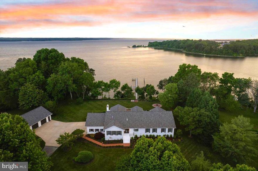 SPOUT FARM ON THE PATUXENT RIVER AND ST. LEONARD CREEK. Discover the epitome of
luxury living at this breathtaking 2.76-acre waterfront estate in the Spout Farm community. This lot is
situated to offer magical sunsets over the Patuxent River with Jefferson Patterson Park as a
backdrop. A sprawling, all-brick 8,000 SF contemporary delivers an expansive open floor plan with
the most beautiful hardwood floors, volume ceilings, perfect natural light, and ideal gathering spaces.
Arrive down a long tree lined drive to an incredible great room - a lasting first impression. You’ll be
drawn to the grand kitchen with a very large prep and cook island, an induction cooktop and built-in
double oven, a dining space with room for those special gatherings, and multi-zone living spaces
with the first of two brick fireplaces. The primary suite offers garden and sunset views over the water
with a gentle flow between sleep, lounge, and a deluxe bath with a heated floor and towel rack.
Exciting for visitors, the finished lower level with a separate entrance includes another full kitchen,
2BR/2BA, a large brick fireplace, more expansive living spaces, and creek views. More important
features include the private pier with 8000LB boat lift, two geothermal systems + commercial water
heater for the ultimate in heat-cool system efficiencies, vaulted ceilings with skylights in just the right
places, laundry service on each level, a deck with multiple zones for the ultimate in outdoor living
space. Your imagination will run wild with ideas about designing your new indoor-outdoor lifestyle
connection. Two impressive executive-sized offices + Xfinity high-speed internet access allow for
complete work-from-home options or perhaps studio spaces. Customize your outdoor space with
two potential locations for an in-ground pool, demonstrated on a concept site plan. Bring your toys
and collectibles to the 35 x 50 detached garage with multiple uses. This building and the attached
800SF+ garage add significant space for vehicles & boats, storage, and a workshop. The home has
been recently upgraded and updated with smart home features, architectural shingles rated for 125
MPH winds, and a security system. The BAT septic system is updated for environmentally friendly
and efficient waste management. This estate is a rare find, offering luxury, privacy, and convenience
in one of the most desirable waterfront locations. The lawn and gardens are
spectacular…established with flowers, shrubs, herbs and berries, fruit and fig. A large, fenced area
exists for the pups. DON’T MISS IT!