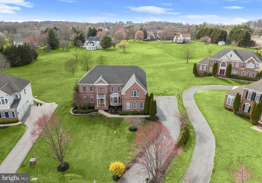 Exquisite Brick Front Colonial in West Friendship’s Prestigious Twin Pines Community.
Nestled in the highly sought-after Twin Pines community of West Friendship, this stunning brick-front colonial offers over 8,000 square feet of refined living space. Meticulously updated with three new HVAC systems (2022), a renovated gourmet kitchen, a new water heater, premium KitchenAid stainless steel appliances, an expansive Trex deck, and more, this home is the epitome of luxury and comfort.  A sun-drenched open floor plan welcomes you, featuring a dramatic two-story family room with a soaring vaulted ceiling, gleaming hardwood flooring, and a gas fireplace framed by breathtaking Palladian windows. The gourmet kitchen is a chef’s dream, boasting an oversized island breakfast bar with a gas cooktop, sleek granite countertops, rich wood cabinetry, and stainless appliances including dual wall ovens. The adjoining morning room, filled with natural light, provides access to the deck, creating the perfect space for seamless indoor-outdoor living. Formal living and dining rooms exude elegance, highlighted by intricate accent molding and an impressive coffered ceiling. A private home office, powder room, and spacious laundry room add convenience to the main level.  The primary suite is a luxurious retreat, offering a spacious sitting room, a bonus room with cathedral ceilings and closets, and a spa-like en suite bath with a dual vanity, soaking tub, and separate shower. Two additional bedrooms are adjoined by a stylish dual-entry full bathroom, while a fourth bedroom enjoys its own private full bath, completing the upper level.  Designed for both grand entertaining and comfortable living, the walkout lower level features a recreation room with a stacked stone fireplace and pellet stove, a custom bar, and a dedicated home theater room. This level also includes an additional bedroom, full bathroom, bonus room, and ample storage space.   Outside, the expansive Trex deck and shaded brick patio overlook breathtaking, picturesque views, offering the perfect setting for serene outdoor living. Ideally located near major commuter routes, with easy access to premier shopping, dining, and entertainment, this extraordinary estate seamlessly blends timeless elegance with modern luxury. Schedule your private tour today.