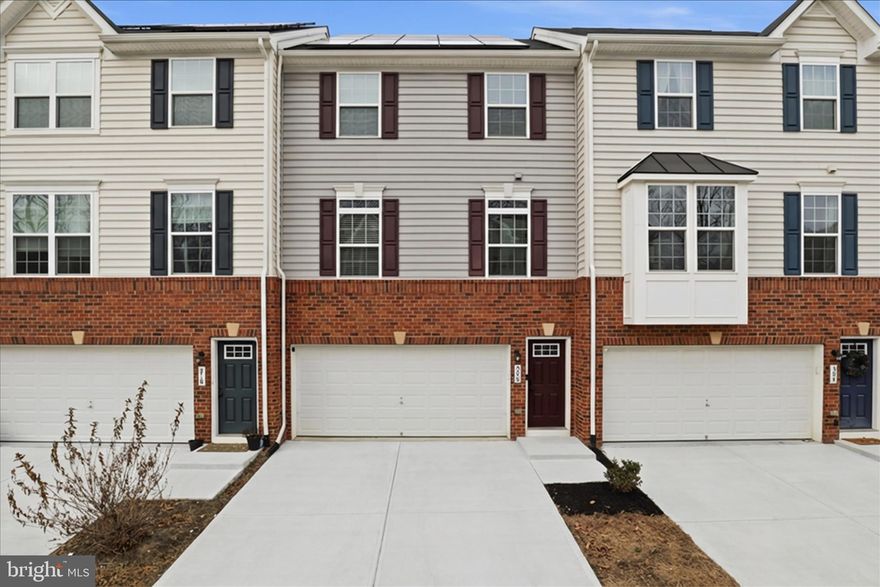 Welcome to modern luxury at 506 View Point Way, a stunning brick-front townhome in the highly desirable Rappahannock Landing community. Located in Stafford County, this home offers a high quality of life with a strong community atmosphere and unparalleled access to I-95, Route 1, the VRE, and historic downtown Fredericksburg.

The expansive main floor features beautiful, wide-plank flooring and a seamless open-concept flow. The heart of the home is the gourmet chef’s kitchen, boasting premium quartz countertops, a massive island with seating, stainless steel appliances, and elegant white cabinetry. Relax in the sun-drenched living area anchored by a modern fireplace with a custom mantel.

The primary suite is a true sanctuary featuring a tray ceiling, an oversized walk-in closet with custom closet organizers, and a luxurious ensuite bath with a dual-sink vanity and a large walk-in glass shower. Two additional bright upper-level bedrooms provide ample space, while the versatile finished lower level offers a secondary living area with direct access to the outdoors.

Enjoy your private composite deck and fenced-in grass yard, or take advantage of Rappahannock Landing’s resort-style amenities, including a swimming pool, clubhouse, fitness center, walking trails, and playgrounds. Ideally situated for families, Rocky Run Elementary serves this home, Edward E. Drew Middle, and Stafford Senior High. This move-in-ready home offers the perfect balance of comfort, convenience, and everyday livability.