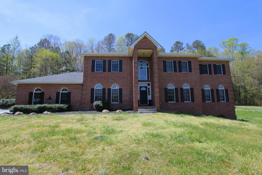 Spacious with upgrades galore! Hardwood throughout, crown molding, chair rail, 2 wood burning brick fireplaces, gourmet kitchen with stainless steel appliances,  9' ceilings, massive 32X18 master suite with separate vanity, bidet, & jetted soaking tub.  5336 square feet of finished living space!  Decking spans the full back of the home complete w/ Pergola. Includes 65X40 Barn.  Beautiful home!