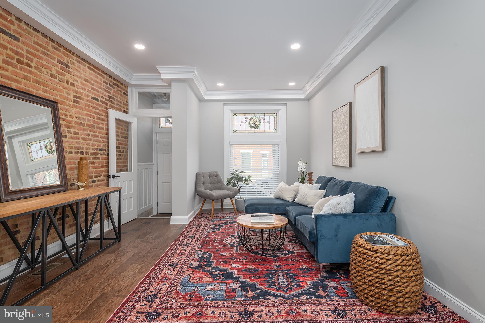 10 YEAR CHAP (based on $240,000 initial appraised value and is pending final approval) 3bedroom+DEN and 3 bathroom renovation with PARKING for a small car. Fully renovated with premium finishes, while preserving its historic beauty, this property features exquisite attention to detail.
Open and inviting floorpan, gorgeous coffer ceilings with lights, exposed brick, custom crown molding, modern fireplace with a reclaimed wood mantle, matte finish solid hardwood floors, custom built-ins with reclaimed wood beams, two-tone chef's kitchen with incredible layout, exotic Gray Nuevo countertop with the trendiest double bevel edge kitchen island .
Second floor features incredibly spacious and airy layout, beautifully restored historic trim and transoms over all doors, offering a large master suite, designer bathroom with newly released line of Italian Calcutta tile , large walk-in shower with crackle glaze subway, as well as a guest bedroom and bathroom, leading you out to a two-tier rooftop deck with incredible views of Baltimore downtown skyline. Lower finished level offers a bedroom, full bathroom and a den with an egress to the rear of the property. Premium location in Brewers Hill, close to all that Baltimore downtown offers, as well as an easy access to restaurants, shopping and to major highways. CHP pre-improvement Appraisal: $240,000.00. Shower glass door is ordered and awaiting delivery.