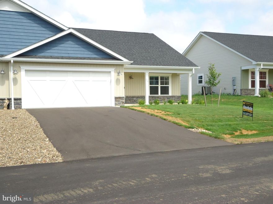 Welcome to this beautifully designed villa that is less than a year old with builder's warranty. This charmer has spacious living and offers a perfect blend of comfort, functionality, and style. This home features 2 generously sized bedrooms and 2 full bathrooms, ideal for those seeking low maintenance living with all the right amenities. Step inside to a bright and open floor plan that seamlessly connects the large kitchen, dining area, and living room—perfect for entertaining or everyday living. The kitchen boasts ample cabinetry, expansive counter space, and modern finishes, making it a cook’s dream. Enjoy year-round relaxation on the sun porch located at the rear of the home, offering a peaceful retreat. The villa also includes a spacious 2-car garage, providing plenty of storage and convenience.  This home includes beautiful cabinetry and fixtures, all LVP flooring. split bedroom plan, large walk-in closet, double vanity, brand new washer and dry and all window coverings convey. Whether you're looking to downsize, invest, or settle into your forever home, this villa offers the perfect blend of charm and modern living in a welcoming community.