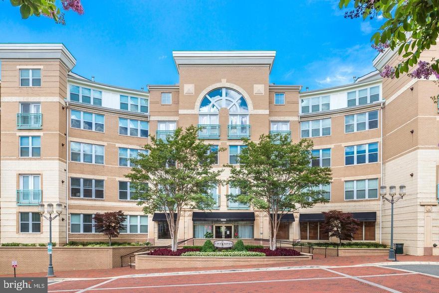 OPEN HOUSE — SUNDAY, JUNE 22ND, 1:00–3:00 PM: Welcome to this beautifully appointed corner unit in the coveted Savoy at Reston Town Center, a rarely available Emerson model offering 3 spacious bedrooms and 2 full baths. Privately positioned on the first floor, this home enjoys a peaceful setting with lush garden and courtyard views and is filled with natural light from 16 large windows. The open layout features 9-foot ceilings and gourmet kitchen with granite counters, 42” maple cabinetry, and GE Profile stainless steel appliances. Two premium garage parking spaces are located just steps from the elevator, and a private, climate-controlled storage unit is included. 
Residents of The Savoy enjoy an array of upscale amenities, including a resort-style pool, furnished gazebo, BBQ grilling stations, fitness center, game and media rooms, business center, secured entry, and 24-hour concierge service.
Outside your door, explore all that Reston Town Center has to offer—from fine dining to retail therapy. Enjoy renowned restaurants such as Ruth’s Chris Steak House, Barcelona Wine Bar, Bar Taco, Morton’s, Capital Burger, Jackson’s, and Sixty Vines. For shopping, you'll find Lululemon, Sephora, Apple, J.Crew, and more, along with everyday conveniences like CVS, LOOK Dine-In Cinema, and cozy cafés including Tatte Bakery, Pitango, and Starbucks.
With immediate access to the Silver Line Metro, Dulles Toll Road, W&OD Trail, and Dulles Airport, this location is unbeatable. Wegmans, Whole Foods, and Target are just minutes away.
Don’t miss your chance to own one of Reston Town Center’s most desirable and well-located homes!