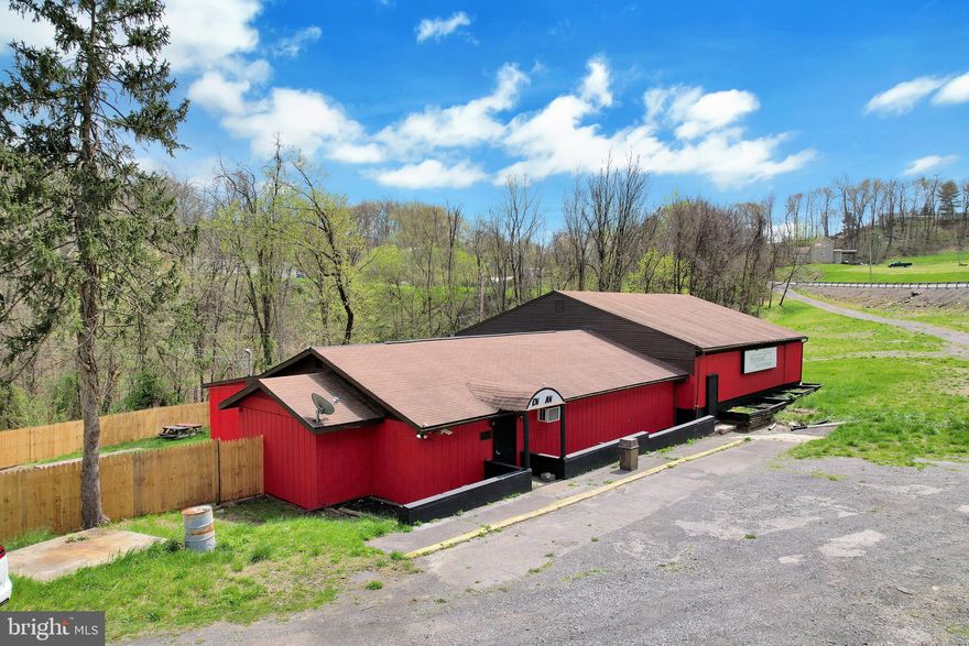 Introducing the previously renowned Legz Gold Lounge, this property boasts approximately 4,787 square feet of finished above-grade space. With two  bar areas, a pool table, an office space, a stage for performances, and dressing rooms/storage facilities, this venue offers ample opportunities for entertainment and events.

Nestled on a .62-acre lot, the property features a fenced-in rear yard, perfect for outdoor seating and gatherings. Conveniently, there are two accesses in and out of the property, along with a spacious parking lot and a two-car garage.

Equipped with forced air oil heat and central air conditioning, comfort is ensured throughout the year. The property also includes three restrooms and a full unfinished basement with over 200 amps of power.

The kitchen comes fully equipped, making it ideal for catering or food service businesses. And let's not forget the breathtaking mountain views that add to the property's charm.

With its limitless possibilities, this property presents an exciting opportunity for various ventures.