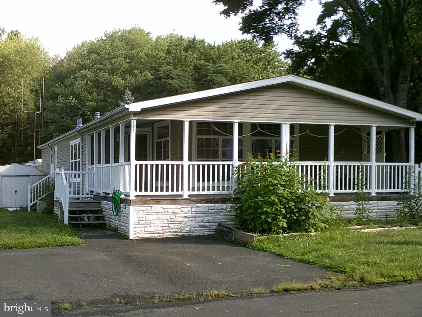 Don't miss out on this outstanding mobile home that is ready for its next owner and is in like brand new condition! This home is part of the Colonial Heritage neighborhood and is one of the largest units it possesses. There is also a lake situated by the home that one can walk to. This home begins with an eat-in kitchen with tons of cabinet space, vaulted ceilings, skylights, and a sliding glass door that leads to a luxurious wrap-around deck on the back of the property, perfect for relaxation or entertainment! In addition to the wrap-around deck, there is also a spacious front porch. The two updated bathrooms in the home also contain vaulted ceilings and skylights. Also included in the home is a gas fireplace perfect for cozy winter nights. The master bedroom suite features his and hers walk-in closets, and a full bathroom made complete with a relaxing Jacuzzi tub. Outside, there is a gardening shed for extra storage. Updates include: a replaced water heater, and the property switched from oil to propane to help with lowering monthly utilities. Lot rent of $645 includes: water, sewer, basic cable, snow on community roads, leaf and trash removal, and maintenance of the common grounds and street. If all of this isn't enough, Colonial Heritage is also conveniently located in the sought after Doylestown, close to Doylestown shopping, close to major traffic routes, desirable schools, close to Doylestown hospital and the local YMCA. This is a wonderful opportunity that won't last and is truly the best bang for the buck!