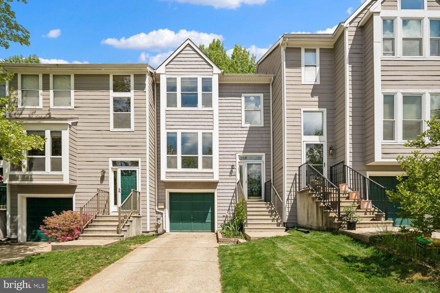 Welcome to this lovely townhome in sought-after Woodland Village with an attached garage and significant upgrades throughout. Designer kitchen with custom built-in bench and wall of cabinetry creates a cozy eat-in area that overlooks the rest of the kitchen with LVP flooring, decorative open shelves, modern white cabinetry and gleaming granite countertops and breakfast bar with room for stools and open to both the kitchen and formal dining room. A slider leads to the replaced Trex composite deck (2023), backing to dense trees with stunning wooded views, making outdoor entertaining convenient and relaxing. The living and dining rooms are light-filled with an open floorplan. The upstairs provides 3 bedrooms including a generously sized primary suite with eye-catching vaulted ceilings, walk-in closet, and attached updated full bath. The finished lower level is a standout space with a den that can be used as a 4th bedroom highlighted by a stylish board and batten wall, and a stunning renovated 3rd full bath with designer touches and custom tile work, making this a perfect space for hosting guests. All this, and a replaced hot water heater and a new high efficiency HVAC (2025)! Ideal commuter location, and this popular neighborhood offers low HOA dues with amazing community amenities including outdoor pool, tennis courts, and playground!