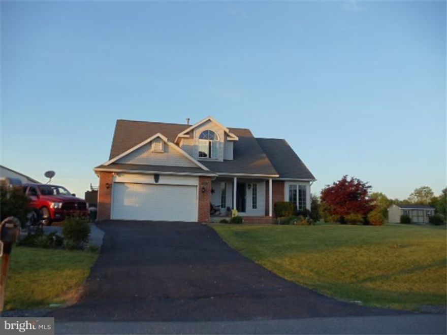 Situated on a spacious 1/2 acre lot with open space behind you, this home offers views for miles as well as elbow space giving you a country feel yet in a welcoming community setting. Enter this home on a brick lined sidewalk and open the front door to an impressive vaulted ceiling living room. The kitchen boasts new floors, counter top and hickory cabinetry and overflows into the family room with French doors that lead out to the deck with spectacular views. The Master bedroom and Master bath both have vaulted ceilings, as does another bedroom! You will find 2 more bedrooms and a full bath on the second floor. The finished lower level offers another 500+ sq ft of living space w a Rec room, as well as another room which adjoins to the 3rd full bath - possible in-law suite? Plenty of parking for all your toys with a 2 car garage and shed big enough to accommodate a car. This is a great house!
