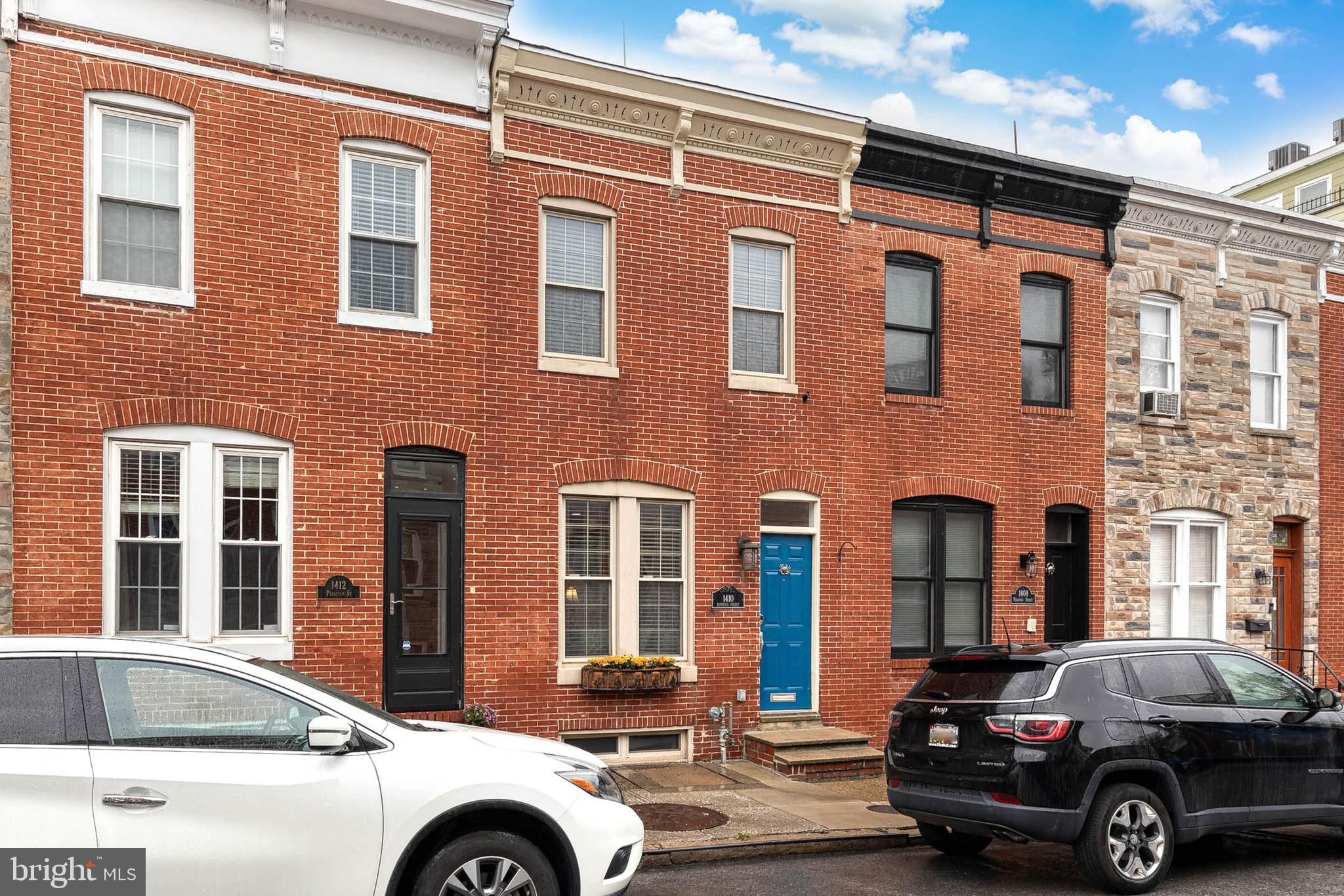 Gorgeous 3 bedroom, 2 full bathroom, 2 half bathroom, and over 2200 finished square foot row home on three above grade levels with a parking pad and an incredible two-tiered roof deck. The classic Federal style home has a beautifully designed main level. The front living room has a custom-built window seat and centers around a charming decorative fireplace. The elegant French country style kitchen with granite countertops and stainless-steel appliances blends beautifully with the surrounding exposed brick walls and hardwood floors. The layout flows to a large dining area off the kitchen, a powder room, and a rear flex room which could be used as an office, mudroom, or additional sitting area. The second level is accessed from the handsome original staircase and has a spacious rear primary suite with a walk-in closet and a luxurious bathroom with a comfortable walk-in shower. The second floor’s front bedroom has tall ceilings accented by the floor to ceiling brick wall. A full hallway bathroom and a laundry area complete the second level. The third level boasts the third bedroom, a half bathroom, and a huge living area with a wet bar and access to the roof decks. The upper-level roof deck is the envy of the neighborhood. The enormous space has unbelievable views of the city skyline and fireworks on the Fourth and New Year’s. Recent improvements include a new roof and roof deck in 2023. The expansive and dry unfinished basement gives plenty of easy storage and includes two work bench spaces. Located on a quiet and highly desirable street, there is immediate access to I-95, BWI, I-83, and Penn Station and an easy walk to the shops of Federal Hill, multiple serene parks, and the Baltimore Promenade. Schedule your tour today!