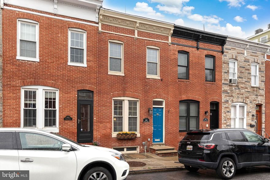 Gorgeous 3 bedroom, 2 full bathroom, 2 half bathroom, and over 2200 finished square foot row home on three above grade levels with a parking pad and an incredible two-tiered roof deck.  The classic Federal style home has a beautifully designed main level.  The front living room has a custom-built window seat and centers around a charming decorative fireplace.  The elegant French country style kitchen with granite countertops and stainless-steel appliances blends beautifully with the surrounding exposed brick walls and hardwood floors. The layout flows to a large dining area off the kitchen, a powder room, and a rear flex room which could be used as an office, mudroom, or additional sitting area. The second level is accessed from the handsome original staircase and has a spacious rear primary suite with a walk-in closet and a luxurious bathroom with a comfortable walk-in shower.  The second floor’s front bedroom has tall ceilings accented by the floor to ceiling brick wall. A full hallway bathroom and a laundry area complete the second level.  The third level boasts the third bedroom, a half bathroom, and a huge living area with a wet bar and access to the roof decks.  The upper-level roof deck is the envy of the neighborhood. The enormous space has unbelievable views of the city skyline and fireworks on the Fourth and New Year’s.  Recent improvements include a new roof and roof deck in 2023.  The expansive and dry unfinished basement gives plenty of easy storage and includes two work bench spaces.  Located on a quiet and highly desirable street, there is immediate access to I-95, BWI, I-83, and Penn Station and an easy walk to the shops of Federal Hill, multiple serene parks, and the Baltimore Promenade.  Schedule your tour today!