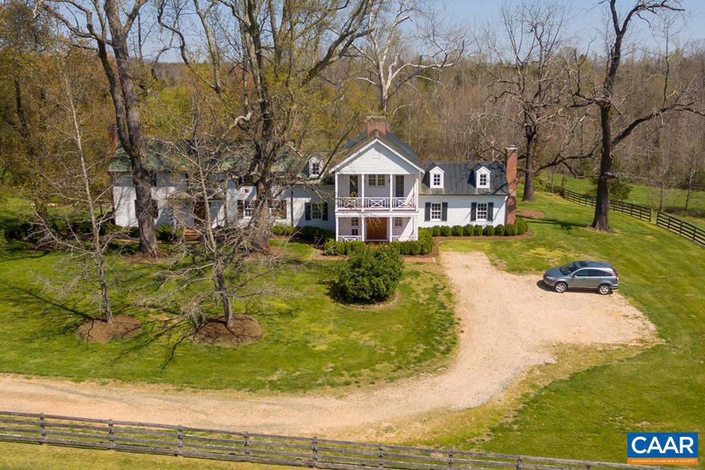 Homestead Farm c. 1800 tastefully combines the original structure, a 1900s expansion, and a late twentieth-century addition, into a beautifully restored country manor house. Highlights include a gourmet kitchen with fireplace, enclosed rear porch which overlooks a pond, butler's pantry, home office and an expansive primary suite. Set on 173 tranquil acres, the grounds feature extensive landscaping, board-fenced paddocks w/ water sheds, and an 8-stall stable w/ wash & tack room. Utilities included, equestrian facilities available for an additional monthly fee. Charm, privacy and modern amenities, all located just 15-20 mins from Charlottesville.