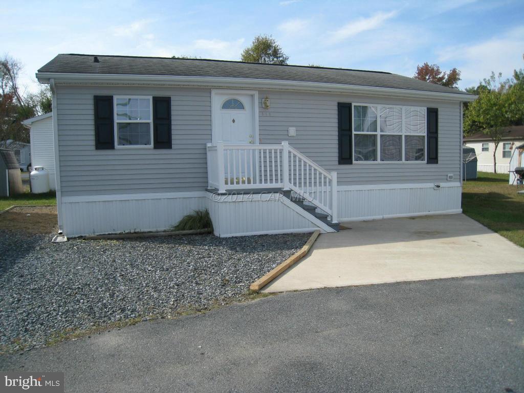 2002 Modular built, partially furnished 2 bedroom inexpensive get-away just minutes from Ocean City beach. NO GROUND RENT. OWN LAND & HOME, NEW STORM DOOR W/VIEW LOOKING DOWN THE ROAD, NEW QUEEN MATTRESS & BOXSPRING, NEW BED SPREAD SET, NEW FRIDGE, ALL NEW BATH ACCESSORIES & PLANTERS, BRAND NEW PAINT, CARPET & KITCHEN FLOORING. Security gated park is located on St. Martin's River, boat ramp, boat storage, large outdoor pool, clubhouse and park cuts your grass. SHOWS GREAT. SEE INSIDE PHOTOS. Priced low. Must enter park with Realtor.