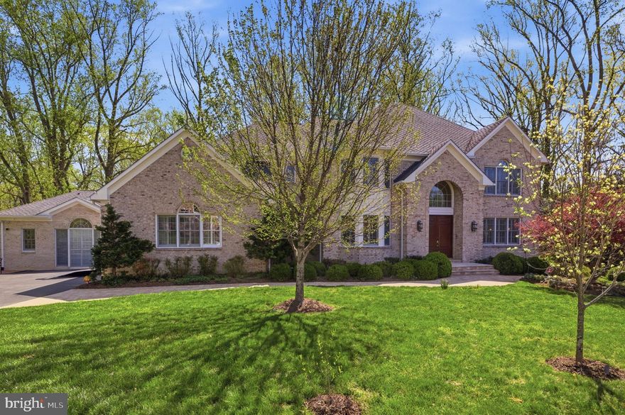 This spectacular all brick colonial, built in 1996 and beautifully renovated, sits on a private 1.6 acre wooded lot with a walk out lower level in the Langley school pyramid, just minutes to Tysons, Vienna, Reston Town Center, and Great Falls.

A standout feature is the amazing connected yet private two level in law suite offering over 3,000 square feet. This exceptional space includes a primary bedroom, two and a half baths, a cathedral ceiling secondary great room, a spacious private kitchen, a dedicated work station hub, and a private entrance. Its own lower level features a finished rec room and a second bedroom, allowing extended family and guests to enjoy complete independence.

The main home offers a dramatic two story foyer, two story family room with gas fireplace, and a formal living room with wood burning fireplace. The renovated chef’s kitchen features Thermador refrigerator and freezer, warming drawer, steam oven, pot filler, and a large island, opening to a dining area and a light filled sunroom with a glass solarium ceiling. A functional service room with island serves as a family foyer with cubbies, work stations, laundry, and pet area. Two half baths complete the main level.

Upstairs, the primary suite includes a sitting room, fireplace, heated bathroom floors, and a walk in closet. Two bedrooms share a Jack and Jill bath and a third has an ensuite. An additional washer and dryer add convenience.

The walk out lower level includes a rec room, media room, bedroom, full bath, wet bar, and storage, plus a bonus flex room ideal for a gym, office, or playroom.

Outdoor features include a sundeck with covered seating, professional landscaping with irrigation, playground area, path to Wolf Trap trails, and a dual zone invisible fence. Additional highlights include a three car garage with specialty bay, whole home Sonos audio, Lutron lighting, motorized shades, reverse osmosis water system, and a three zone HVAC system with a separate solarium system.

Nearly $1.2 million in upgrades complete this exceptional offering.