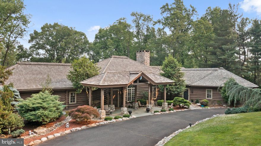 Bring Aspen, Colorado to you! This is a true Log Cabin inside and out, even the outside is authentic, tranquil, very open but in a private setting.   Living Room with 28 ft. ceiling, stone floor to ceiling double sided fireplace, gorgeous wood floors throughout man level.  Dining Room has a tile floor and 18 ft. ceiling, newer  Kitchen with granite counters, gas cooking, ceramic tile backsplash, large island, two sinks, desk area and an entrance to the indoor exercise pool room, 2 powder rooms and a large laundry room. The Primary Suite connects through Den /Office and the Primary has a hand painted gorgeous fireplace, wall of windows that overlooks the backyard, his and her closets.   The Primary on-suite has a stall shower and soaking tub. The lower level has 3 enormous Bedrooms, 2 with fireplaces,  one with it's own Bath, large hall bath and a fantastic Family Room with doors to an outside wet bar, great for entertaining. There is an exercise room that could be a 5th Bedroom. House has central vac, 3 car garage, irrigation system and a sound system throughout. Spectacular home to say the least and the pictures do not do it justice.  This is a must see in person fabulous home situated on a gorgeous piece of property.