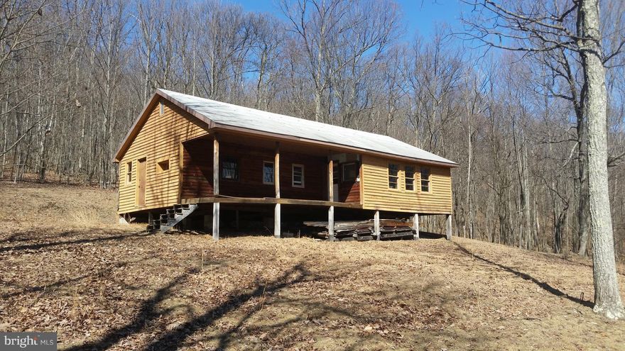 59.1 Private Unrestricted Acres, mostly wooded & gently rolling, perfect for hiking, hunting, and trail riding would make and excellent retreat location at less the 2.5 hours from the metro area. There is an older cabin shell built around a trailer with newer septic system & electric near. The land has a road system for easy travel and in the timber management for reduced taxes. Cabin sold As-Is.