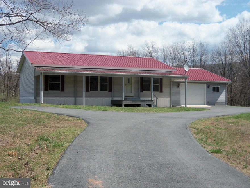 One level living on fairly level, mostly cleared lot.  Attached two car garage, paved driveway on a small dead end lane with only about 8 houses.  Freshly painted inside. Covered back porch with nice views. Some restrictions but no HOA in effect at this time.  Approximately 7 miles southeast of Berkeley Springs, WV.