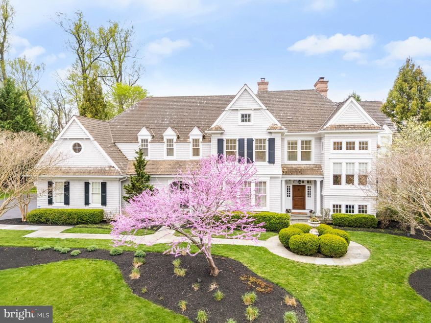 Driving into the exclusive Springhouse enclave feels like a serene escape to the countryside with its lush open spaces, split-rail fences, walking trails and majestic trees. Located at the end of a private cul-de-sac is a breathtaking custom-built home designed by McIntyre Capron architects and crafted by renowned builder, Mike Mirarchi of MJ Mirarchi Builders. From the moment you arrive, this Hampton shingle-style residence is captivating. Follow the flagstone pathway to the front entrance. The striking exterior is beautifully framed by professionally designed landscaping set on nearly an acre of property. Step inside the grand foyer. There is an immediate feeling of understated elegance which creates a warm and welcoming atmosphere. Notice the stunning walnut flooring, custom millwork and soaring ceilings throughout. You will be instantly drawn to the spacious formal living room with a gas fireplace adorned by a walnut mantle and resplendent with a wall of windows overlooking the pool and pool house. To your left is the formal dining room, illuminated by two antique brass and crystal chandeliers. A butler’s pantry with display cabinets for dishes and glassware, bar sink and wine refrigerator is conveniently located just outside the dining room. To the right of the living room is a private study with French doors, featuring built-in shelving and cabinets, a gas fireplace and rich walnut trim and wainscoting. A powder room and coat closet are to the right. The family room and adjacent kitchen are the heart of the home. A wall of windows with a double French door offers panoramic views of the patio, pool and backyard. Coffered ceilings and a gas fireplace surrounded by built-in display shelves and cabinetry, create an inviting gathering room for family and friends. No details were spared in designing the gourmet chef’s kitchen, from top-of-the-line appliances and cabinetry to the ten-foot quartz island. A recently added breakfast room with a dramatic vaulted ceiling, surrounded by windows overlooking the pool, is ideal for casual dining. A potting room with a sink and a built-in desk area with cabinets is off the kitchen. Also off the kitchen is another entrance to the front of the home and mudroom, featuring a large walk-in pantry, cleaning supply closet, coat closet, second powder room and access to the three-car garage.  A back staircase leads to the second floor. In the foyer are the main stairs leading to the second floor. Extra wide stairs and windows at the landing with a built-in window seat add additional layers of handsome architectural features. At the top of the stairs, enter the double doors to the luxurious primary suite, with a barrel-vaulted ceiling and a gas fireplace. Arched transom windows over French doors lead to a Juliette balcony, overlooking the pool, patio and backyard. Enviable double master bathrooms and expansive walk-in closets offer unmatched privacy and comfort. Four other generously sized bedrooms, each with ensuite bathrooms and walk-in closets, are located on the second level as well as a linen closet and sizable laundry room. The lower level features a second kitchen, workout room, game/billiard room, full bathroom, and media area. Not to be missed is the spectacular, resort-like setting of the backyard with a travertine tiled patio and pool. A pool house, wrapped in windows, embodies ultimate luxury with a cozy sitting area, a floor-to-ceiling stone fireplace, a wet bar, a bathroom and outdoor shower. The prime location of the home allows for easy access to major commuting routes, shopping and restaurants. Although located in the award winning Marple-Newtown School District, there are numerous private schools in the area. This special home has been meticulously maintained by the current owners with updates throughout. It showcases extraordinary attention to detail in every way, making it a truly exceptional opportunity. Call now to schedule an appointment to see this stunning home.