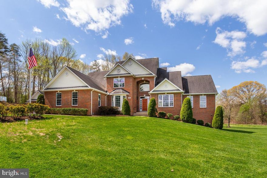 Welcome to your ideal multi-generational retreat, where luxury meets practicality in the heart of Davidsonville. This expansive property offers a haven for families of all sizes, boasting a main house brimming with elegant features and a separate in-law suite for added privacy and convenience. Main house has an elegant two-story foyer, two story family room with stone fireplace, separate dining room with pocket doors for the option of private dining, French doors from both the dining room and kitchen lead to the screened porch - perfect for outdoor dining or just relaxing & enjoying the serenity & view! 
 The spacious kitchen has granite counters, a central island, and stainless steel appliances. The living room offers a great view of the sweeping front yard, and the home office with bay window can also be used as a 7th bedroom. The main level owner's suite includes a huge walk in closet with custom built-ins and a large bathroom with soaking tub, separate shower, and two vanities. Upstairs you'll find 3 more bedrooms and 2 full baths. The walkout basement has a rec room, full bath and amazing workshop for the woodworking enthusiast, and with the framework already in place (studs throughout), you can effortlessly transform the unfinished space into a home gym, media room, and additional living quarters - or keep it as storage!  The in law suite has 2 bedrooms, 2 full baths, kitchenette, laundry, living room, family room and 1 car garage! Nestled on a generous 9.67-acre lot, this property offers unparalleled privacy and the opportunity to immerse yourself in nature's beauty throughout the four seasons. Well replaced 2023. Level 2 Car Charging circuits in both garages.