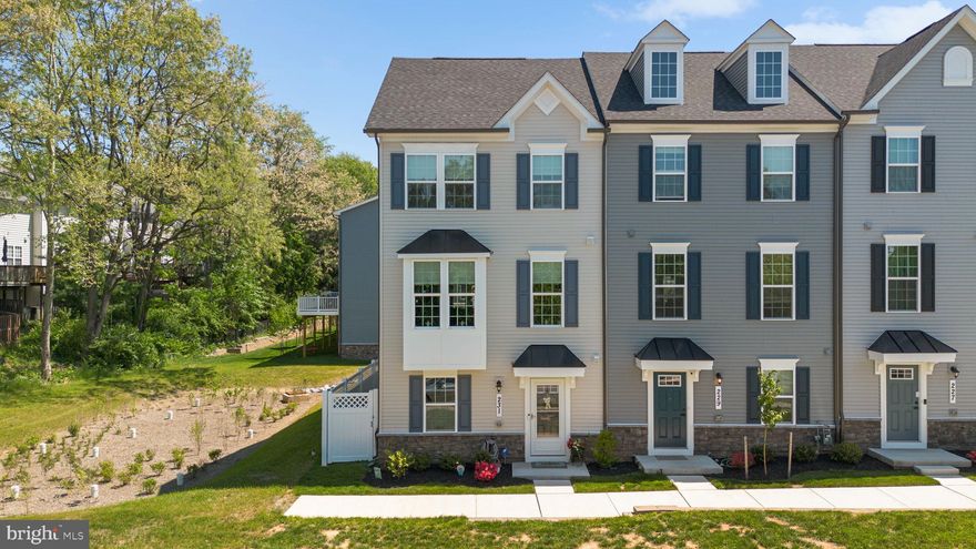 The love that the sellers have for this upgraded 3 bedroom, 2 full bathroom, 2 half bathroom end-unit townhome is apparent from the moment you walk in the front door. Built in 2025 and lightly lived in, this home offers the benefit of newer construction along with thoughtful upgrades selected at build time and after move-in. From the exterior to the interior, the property has been meticulously cared for and shows exceptionally well.
The main level offers an open floor plan with high ceilings and a strong sense of flow between the kitchen, dining area, and family room. The gourmet kitchen is a standout feature, complete with quartz countertops, a large center island with sink, five-burner stove, butler pantry, generous cabinet storage, and ample prep space. The separate dining area sits just off the kitchen and provides direct access to a spacious deck, enhanced by an added screen door. A separate family room creates a defined living area while maintaining the openness of the main level. A convenient half bathroom is also located on this floor.
The upper level includes 3 bedrooms and 2 full bathrooms. The primary suite features a tray ceiling, a large walk-in closet with custom built-in shelving and storage, and a private bathroom with dual vanities, a tub, and a separate shower. The additional bedrooms offer comfortable proportions and include installed lighting, one of several upgrades completed when the home was built.
The lower level expands the home’s usable space with an office/den/possible 4th bedroom, highlighted by custom barn doors. This level also includes a half bathroom and a large storage area, making it easy to keep seasonal items, household essentials, or hobby equipment organized. The garage has a finished epoxy floor, giving the space a clean and durable finish.
Additional upgrades include upgraded window treatments, lighting in all bedrooms, the finished garage floor, and the screen door leading to the deck. The end-unit setting adds to the appeal, while the location offers convenient access to walking trails, a nearby playground, Baker Park, Downtown Frederick, Starbucks, grocery stores, restaurants, shops, I-15, commuter routes, and the Frederick MARC station. A discounted YMCA membership is also available. This is a well-appointed townhome with modern finishes, practical upgrades, and a convenient Frederick location.