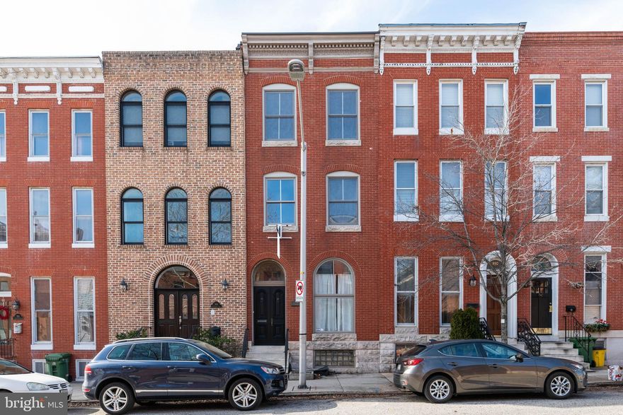 Welcome to the lively neighborhood of Canton!  This unique four-level,  stunning colonial row home is ready to be your new home!  This beautiful home is  appointed with a gourmet kitchen,  fenced back yard, and a wet bar on the top level, perfect for entertaining on the deck while overlooking Baltimore City.   It features hardwood floors, crown molding and amazing natural light throughout.  3 decks and a fenced backyard with your own green space makes this home perfect for your furry friends, little ones or for the backyard BBQ.  Create your own master Suite on your own private floor with a wet bar for your convenience.  Custom Closets are just one of the many details of this home you will fall in love with.  The basement is walkout and has its own separate entrance for roommate potential!  Only two blocks from Canton Square where you can find shopping, restaurants and night life!  Hurry, you won't want to miss this one!