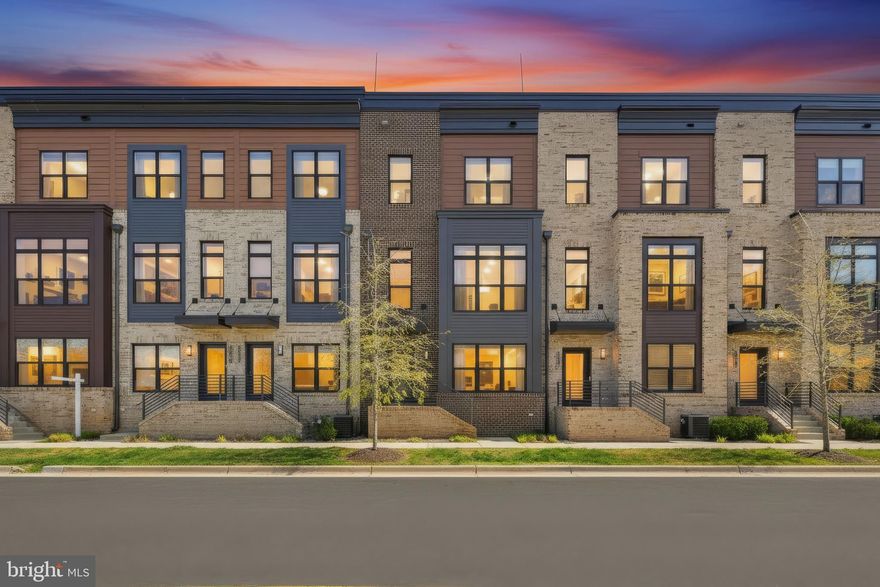 Experience elevated luxury in the prestigious Tower Oaks community, where tranquility and convenience meet. Set in a quiet, tucked-away enclave yet moments from I‑270, this residence offers effortless access to neighborhood favorites like Clyde’s Tower Oaks Lodge and nearby parks—just a short stroll across the street.

Residents enjoy exclusive access to the CORE clubhouse, a vibrant, amenity-rich retreat featuring a state-of-the-art fitness center, yoga studio, seasonal pool, weekly Hearts, Canasta, and Mahjong games, creative arts and crafts space, and cozy seating nooks perfect for unwinding. Heated outdoor patios with grill stations, community happy hours, and visiting food trucks create a warm, social atmosphere for those who value both privacy and connection.

Completed in 2021, this four-level EYA townhome is perfectly positioned to capture warm afternoon light. The entry level features a versatile private suite—ideal as an office or guest bedroom—enhanced by frosted-glass French doors, a full bathroom, and a built‑in Murphy bed for effortless flexibility. This level also provides direct access to the spacious two‑car garage, thoughtfully outfitted with abundant storage.

The main level is bright, open, and designed for modern living and entertaining. The kitchen, dining, and living areas flow seamlessly and are surrounded by expansive windows. Off the kitchen you'll find a walk-out composite deck perfect for enjoying your morning coffee. A stylish powder room completes this level.

Upstairs on the third level, the primary suite features an oversized walk-in closet and a spa-inspired bath with dual vanities and a glass-enclosed shower. Two more bedrooms plus the laundry complete this floor.

The top level offers a spacious family room, a fifth bedroom with a full bath, along with a private rooftop terrace equipped with electricity allowing the option to add an outdoor tv or awning—perfect for year-round enjoyment and effortless indoor-outdoor living.