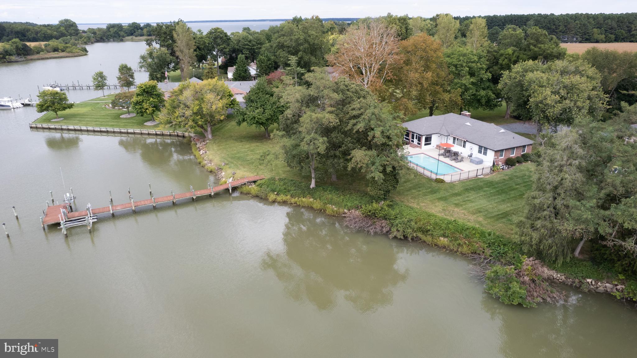 **Property Description: Waterfront Brick Rancher with Stunning Sunsets**
Welcome to your dream waterfront retreat! This charming brick rancher features 3 spacious bedrooms and 2 full baths, perfect for a vacation rental or your forever home.
As you step inside, you'll be greeted by stunning hardwood floors that flow throughout the home. The inviting living room boasts a brick wood-burning fireplace and picturesque views of Jenkins Creek, creating a cozy atmosphere for relaxation. Enjoy breathtaking sunsets from the comfort of your living space as the day winds down.
The den, complete with built-in shelves, offers a great space for reading or a home office. Enjoy formal dining in the elegant dining room, which features sliding doors that lead to a screened porch, ideal for entertaining while overlooking the in-ground pool and the serene water views, perfect for sunset gatherings.
The updated kitchen is a chef's delight, featuring laminate countertops, a large farm sink, an electric cooktop, a wall oven, a microwave, and a refrigerator with an ice maker. The generous walk-in pantry ensures ample storage space for all your culinary needs.
Conveniently located, the laundry room includes a washer and dryer, a tub sink, and an additional toilet.
The primary bedroom offers a tranquil view of the pool and creek, along with double cedar closets for all your storage needs. Its accompanying bath features ceramic tile flooring and a stall shower.
Two additional bedrooms are well-appointed, one measuring 13’ x 11’ and the other 12’ x 11’, both with cedar closets for a touch of warmth and character.
Step outside to the concrete patio that surrounds the in-ground pool and hot tub/spa, complete with a Sun Setter awning for shade on sunny days.
For water enthusiasts, the property includes a pier with electric and water access, along with a boat lift and a jet ski lift, making it easy to enjoy life on the water.
With gorgeous sunsets painting the sky every evening, this waterfront brick rancher offers the perfect blend of comfort, style, and outdoor adventure. Don’t miss your chance to own this incredible property!