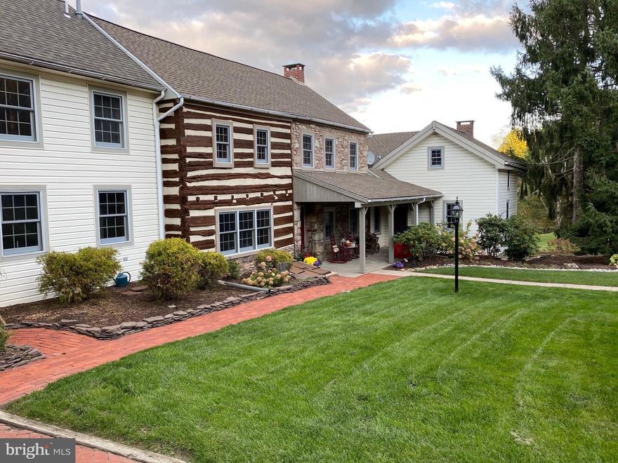 Serenely set on 12.34 acres, this meticulously cared for property offers a log and stone farmhouse, well equipped outbuildings, and breathtaking grounds with stellar outdoor amenities comprise picturesque Hawk Ridge Farm. At the heart of the estate is a circa 1735 main house. Beautifully appointed rooms incorporate modern upgrades with original details. The first floor library boasts an original walk-in fireplace, exposed wood beams, and deep silled windows. A vaulted ceiling and wood burning fireplace enhance the inviting family room. Steps away, top-of-the-line appliances and granite countertops shine in the gourmet kitchen with island and sliding doors to a maintenance free deck.  A portion of the house with separate entry,  brings privacy for guests with a fireplace, full bath, and loft bedroom. Entertaining flows from the finished lower level game room with wet bar and sauna to the sparkling swimming pool, tennis court, paver patios, and covered deck. Temperature controlled with exposed stone walls and two levels of finished space, the renovated Pennsylvania bank barn adapts to changing needs. A relaxing full-time residence or a luxurious weekend/summer property, this extraordinary complex unites beauty and function and is easily reached from Philadelphia and the Lehigh Valley.