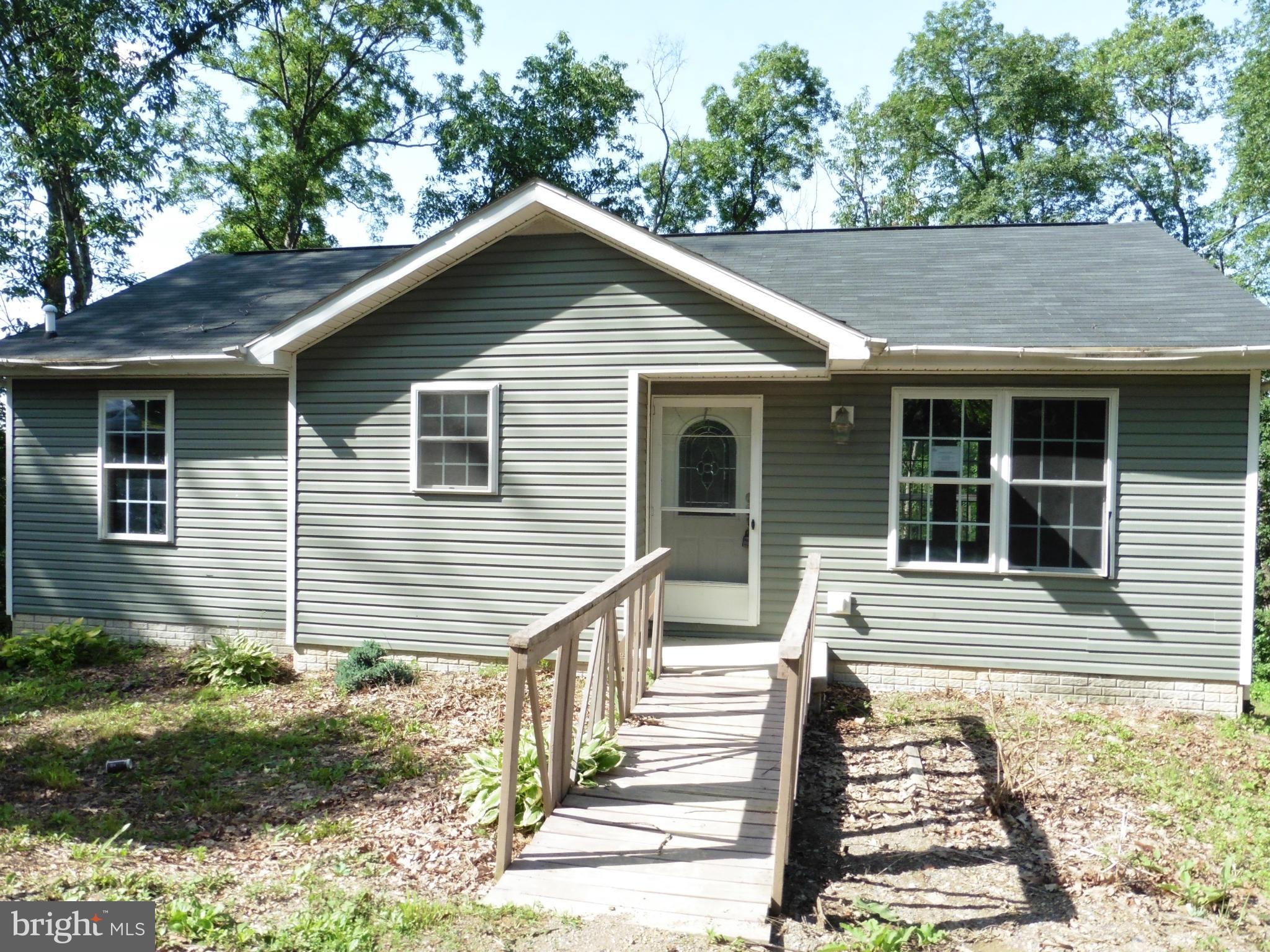 REDUCED! No better rehab value in the area! Country rancher with loads of potential. Partial basement finish includes bath and kitchen set up although unfinished. Seller offering up to $500 for Home Warranty for owner occupants. Cool off - lot path leads down to stream. Sold As-Is.
