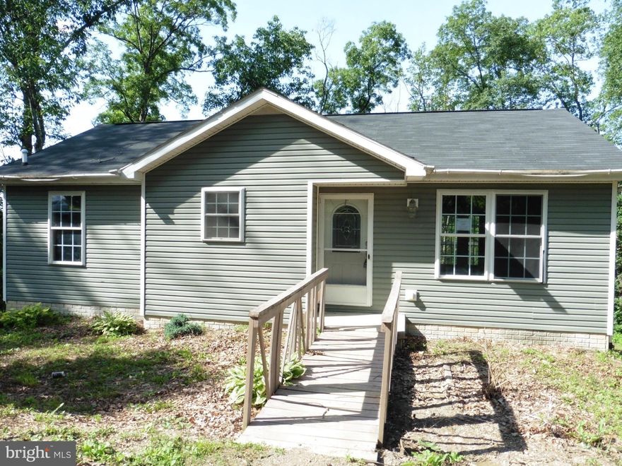 REDUCED!  No better rehab value in the area!  Country rancher with loads of potential.   Partial basement finish includes bath and kitchen set up although unfinished. Seller offering up to $500 for Home Warranty for owner occupants. Cool off - lot path leads down to stream. Sold As-Is.