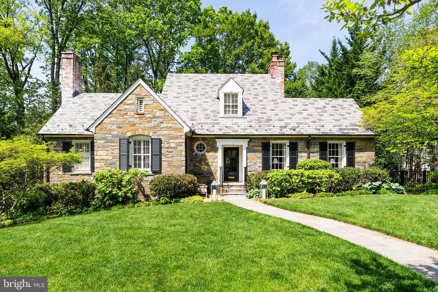 Nestled on a charming tree-lined street, this enchanting field stone cottage at 5045 Millwood Lane NW offers a sanctuary in the city. This home marries elegance with cozy charm, presenting an idyllic lifestyle just a stone's throw from the vibrant shops and restaurants of Palisades and Spring Valley Shopping Center.

Spanning 4,100 square feet of living space, the residence boasts a gracious main level primary suite, creating a serene retreat. The remodeled kitchen is a culinary masterpiece, equipped with top-tier Wolf and Viking appliances, perfect for the discerning chef. The home's warm ambiance is accentuated by three fireplaces, inviting you to unwind in front of a crackling fire.

The upper level boasts three bedrooms, with two featuring delightful secret hideaway playrooms, adding a touch of whimsy and wonder. Built-in bookshelves throughout offer both functionality and a nod to timeless design.

Beyond the interior, the home extends into a professionally landscaped English garden, an outdoor oasis set on almost a quarter-acre lot. Whether entertaining or enjoying a quiet moment, this garden is a picturesque setting. The property also includes a garage accommodating two tandem spaces, offering ample storage.
This residence is more than a home; it’s a charming retreat that promises an exquisite lifestyle in the heart of Washington, DC.
