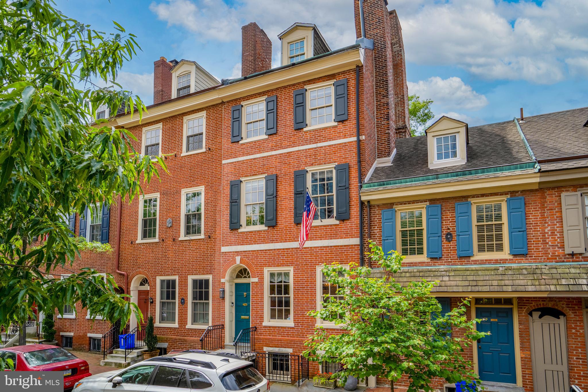 Quintessential 1810 Society Hill Federal Townhouse on Delancey Street for Sale. Enter the classic brick facade to an elegant interior with a vestibule, high ceilings, large random width pine flooring, and lovely arched doorways framing the view to the interior. Host dinner parties for friends and family in the beautiful dining room with built-in shelving, wainscoting, intricate woodwork trim, and a gas fireplace with a marble surround. In the hallway, there is a convenient half bath leading to the kitchen. Some highlights there are the stainless steel appliances including a 4 burner Five Star gas range, a Sub Zero refrigerator, a storage area for coats, quartz countertop, and the custom shaker cabinetry. The living room features three skylights, a gas fireplace, and french doors opening into the lush garden. The backyard is a peaceful retreat that is beautifully landscaped with a slate patio and a built-in barbecue. Upstairs, you'll find four spacious bedrooms, each with its own unique character and charm. The master suite encompasses the entire 2nd floor with a walk-in closet, a gas fireplace, and a lovely master bathroom with double sinks and a carrara marble tiled shower floor. The 3rd floor has 2 additional bedrooms and a full bath and the 4th floor has a bedroom and a convenient home office with a southern facing deck offering fantastic views of the city and St Peters steeple. Wine lover perhaps, the lower level is simply sublime for the enthusiast.. a temperature controlled wine cellar and tasting room. Relax tasting the latest release by the fireplace while listening to music on the Sonos sound system. Additionally, the lower level includes a full bathroom, the washer/dryer, mechanicals, and a second entrance to Delancey Street. Located in Society Hill, a historically preserved neighborhood, with enchanting green spaces such as Three Bears Park, Spruce Harbor Park, and Independence Park while also a mere blocks away from nationally renowned restaurant Zahav and a local favorites Malbec and Pizzeria Stella, cafes, Ritz theaters. Also, blocks from the entrance to 95 and 676 and only a 15 minute ride to the airport.