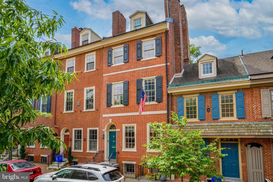 Quintessential 1810 Society Hill Federal Townhouse on Delancey Street for Sale.  Enter the classic brick facade to an elegant interior with a vestibule, high ceilings, large random width pine flooring, and lovely arched doorways framing the view to the interior. Host dinner parties for friends and family in the beautiful dining room with built-in shelving, wainscoting, intricate woodwork trim, and a gas fireplace with a marble surround.  In the hallway, there is a convenient half bath leading to the kitchen. Some highlights there are the stainless steel appliances including a 4 burner Five Star gas range, a Sub Zero refrigerator, a storage area for coats, quartz countertop, and the custom shaker cabinetry. The living room features three skylights, a gas fireplace, and french doors opening into the lush garden. The backyard is a peaceful retreat that is beautifully landscaped with a slate patio and a built-in barbecue. Upstairs, you'll find four spacious bedrooms, each with its own unique character and charm. The master suite encompasses the entire 2nd floor with a walk-in closet, a gas fireplace, and a lovely master bathroom with double sinks and a carrara marble tiled shower floor. The 3rd floor has 2 additional bedrooms and a full bath and the 4th floor has a bedroom and a convenient home office with a southern facing deck offering fantastic views of the city and St Peters steeple.  Wine lover perhaps, the lower level is simply sublime for the enthusiast.. a temperature controlled wine cellar and tasting room.  Relax tasting the latest release by the fireplace while listening to music on the Sonos sound system.  Additionally, the lower level includes a full bathroom, the washer/dryer, mechanicals, and a second entrance to Delancey Street.  Located in Society Hill, a historically preserved neighborhood, with enchanting green spaces such as Three Bears Park, Spruce Harbor Park, and Independence Park while also a mere blocks away from nationally renowned restaurant Zahav and a local favorites Malbec and Pizzeria Stella, cafes, Ritz theaters.  Also, blocks from the entrance to 95 and 676 and only a 15 minute ride to the airport.
