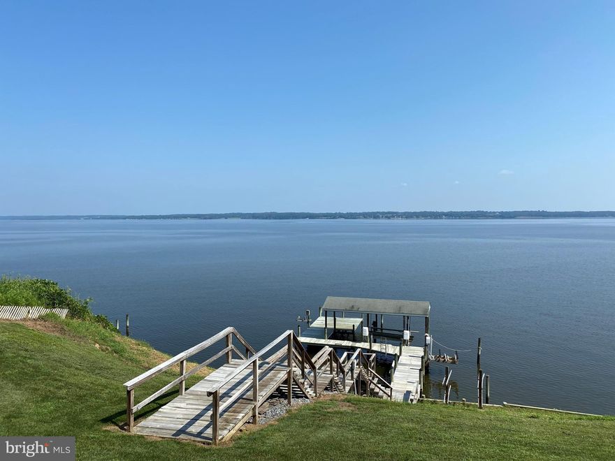 Waterfront! Waterfront! Waterfront! Beautiful expansive views of the Patuxent River that simply cannot be beat! This lovely 3 bedroom home has been cared for meticulously.  New gas fireplace and stone face add warmth to the living area which is wide open to the kitchen. Four sliding glass doors on the main floor offer panoramic views of the river. All new laminate hardwood flooring on the main level with new tall baseboard throughout, as well as 9' ceilings. Shaker style cabinets with granite countertops and stainless appliances add charm to the open concept kitchen. New dishwasher and new washer and dryer are an added wonderful touch. The deck is composite with vinyl railings, perfect for entertaining friends or simply enjoying a morning cup of coffee while watching the sunrise.  Both hvac units are new/newer, the downstairs unit was replaced in 2019 and the upstairs unit was replaced in 2021.  The crawlspace was completely overhauled in 2019, adding vapor barrier and dehumidifier. One might say the creme de la creme is the beautiful backyard and covered pier, which truly is a rare find.  The pier is home to a boat lift and two jet ski lifts bringing all the elements of waterfront living together. Crabbing, fishing, boating, floating---it all happens here! I simply can't say enough good things about this home--it's a beauty, plain and simple!  You just won't want to leave!  ***professional pics on 8/31***     Pool table, shuffle board and dart board to convey.