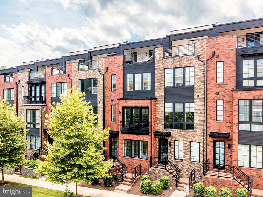 Experience elevated modern living in this ultra-sleek, four-level Toll Brothers townhome at 1974 Roland Clarke Place in Reston. Built in 2020, this contemporary gem stuns with engineered wood floors, tall windows, oak stairs with iron balusters, and an open, airy layout flooded with natural light. The main level features a sprawling great room with a custom modern fireplace, open-concept dining, and a designer kitchen outfitted with a dramatic quartz waterfall island, stainless steel appliances, wall oven, range hood, sleek cabinetry, and custom lighting—perfect for entertaining. The primary suite offers dual walk-in closets and a spa-inspired bath with a soaking tub, rainhead shower, dual vanities, and quartz countertops, while the secondary suite also features spa-style finishes and elevated design. A spacious entry-level bedroom with full bath offers privacy for guests, and the fourth-level loft with wet bar rough-in and powder room flows seamlessly to the expansive rooftop terrace—both covered and uncovered—piped for natural gas grilling. Enjoy added ease with laundry on the bedroom level, a two-car garage, and plenty of overflow parking. With walkability to TWO Metro stations, Wegmans, Gold’s Gym, the Reston National Golf Course, community pool, and an array of restaurants, this home delivers luxury and location in one stunning package. Reston offers 15 pools, 55 miles of trails, numerous parks, 4 beautiful lakes, 52 tennis courts, 18 pickle ball courts, a variety of community events and programs throughout the year, including festivals, concerts, workshops, and social gatherings, several community centers, including the Reston Association's main headquarters, the Walker Nature Center, and the Lake House at Lake Newport, which offer spaces for community meetings, classes, and special events. Easy access to Dulles Int'l Airport, Dulles 267 Toll Road, FFX County Pkwy and more.