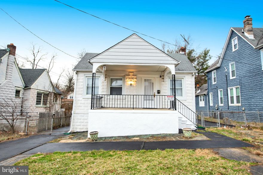 Charming Bungalow with covered front porch, off street parking and large fenced backyard. Property features three spacious bedrooms all with wood floors, living room with inlaid wood floors and decorative fireplace, formal dining room, updated bath with walk in ceramic tile shower.  Kitchen has laminate floors, gas stove and refrigerator. There are stairs that walk up to attic, great space for storage. Unfinished lower level with laundry tub and tons of potential. Wonderful home at a great value.