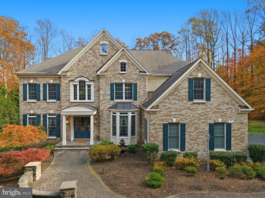 Welcome Home to 9712 Thorn Bush Drive! Nestled in the highly sought-after Estates at Rosedale, this stunning Colonial sits on a private 5.22-acre lot surrounded by mature trees and peaceful scenery — your own serene retreat just minutes from everything you need. Arrive via a long, private driveway that sets the tone for what’s to come. Step through the front door into a grand two-story foyer with a sparkling new chandelier and gleaming hardwood floors that flow throughout the main level. The heart of the home is the sun-drenched family room, where soaring two-story windows frame beautiful views of the property and fill the space with natural light. The gourmet kitchen is a chef’s dream — featuring abundant cabinetry, an oversized walk-in pantry, and generous counter space perfect for cooking or entertaining.
Step out onto the expansive deck that spans the back of the home, complete with a screened-in gazebo and dual staircases leading to the backyard — ideal for gatherings or quiet evenings outdoors. Upstairs, accessible by two staircases, you’ll find four spacious bedrooms, three full baths, and a convenient laundry room. The primary suite is a true retreat, with panoramic wrap-around windows offering gorgeous seasonal views. The renovated ensuite bath boasts a new glass shower, stylish tile surround, and updated fixtures — and the massive walk-in closet is sure to impress even the most dedicated fashion enthusiast! A junior primary suite and a Jack & Jill bath connecting bedrooms three and four complete the level.
The fully finished walk-out basement adds exceptional living space, featuring a large rec room with a wet bar and island seating, built-ins, a home gym, and a fifth legal bedroom with a full bath — perfect for guests or an in-law suite. Don’t miss the huge storage and utility room, ideal for keeping everything organized. The three-car garage is finished with custom flooring and heavy-duty cabinetry — a dream setup for hobbyists or car enthusiasts. Perfectly located just off Ox Road, this home offers the best of privacy and convenience — only 9 minutes to Laurel Hill Golf Club, and close to top-rated schools, shops, and restaurants. Move in before the holidays and start making memories in your new forever home. Welcome & Enjoy!