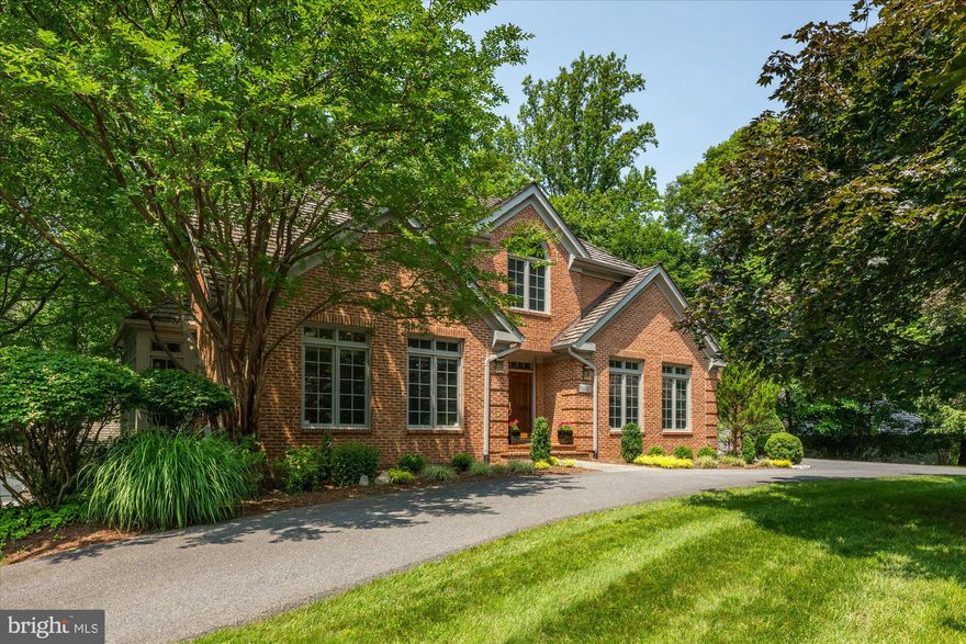 This home is a showstopper!  Set on a beautiful corner lot with a circular drive, this all-brick home sits proudly atop a gentle knoll, offering exceptional curb appeal from the moment you arrive.  Step inside and prepare to be surprised.  While you might expect a traditional colonial layout, this home greets you with a soaring two-story foyer and an open floor plan filled with natural light.  The flow is gracious and inviting, perfect for both everyday living and entertaining.   These original owners have poured their heart and soul into this home and it shines throughout!  The main level offers expansive formal Living and Dining Rooms, a home office and a sunroom (possible 2nd office!) and a stunning, recently renovated Kitchen that opens seamlessly into the Family Room.  The Chef's Kitchen is a show piece featuring high-end finishes and thoughtful design sure to impress.  A large laundry room and direct access to the two-car garage complete the main level.  Upstairs, the private and peaceful Primary Suite offers a luxurious marble bathroom with a separate soaking tub and shower.  Four additional bedrooms and two full bathrooms provide plenty of room for family and guests.  One of the secondary bedrooms features a vaulted ceiling and a beautiful Palladian window, adding architectural interest and light.  The daylight, walk-out lower level boasts high ceilings, stylish luxury plank flooring and sliding glass doors that lead to the serene rear yard.  There's also a bonus room (guest bedroom/exercise room), a half bath and a very large unfinished storage area that could easily be finished to suit your needs.  Out back, enjoy the peaceful beauty of mature trees and complete privacy.  Whether you're relaxing on the deck after a long day or entertaining friends on a summer evening, the setting is simply magical.  Located just minutes from the Clara Barton Parkway, I-495/the Beltway and Great Falls National Park, this home offers the perfect balance of convenience and tranquility.  Hiking, biking, kayaking and birdwatching await just moments  from your door.  You'll feel like you are on vacation every day! Access to Regan National  and Dulles International Airports is a breeze with the parkway access! All this in the prestigious Avenel community offering access to the Avenel Swim/Tennis Club with pickleball courts and an adjacent 30 acre Montgomery County park with baseball and soccer fields, tot lots and walking paths.   And---this is the coveted Whitman School Cluster.  Easy, elegant living in a truly special home - make it yours today!