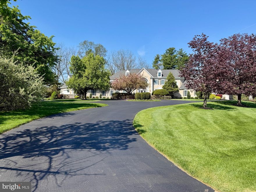 Welcome to 5 Wingate Court, an exceptional French Normandy–style residence gracefully positioned at the end of a quiet cul-de-sac in the coveted Country Club Estates. Set on nearly two picturesque acres bordering the Philadelphia Cricket Club golf course, this elegant home offers 5 bedrooms, 4 full and 2 half baths, and approximately 5,959 square feet of thoughtfully designed living space. A grand two-story foyer sets the tone for the home’s timeless appeal, leading to a step-down living room with fireplace and an inviting formal dining room. The expansive great room features a fireplace and custom bar, creating an ideal setting for both entertaining and everyday living. A distinguished library with custom cabinetry offers a refined workspace, while the adjacent sunroom fills the home with natural light. The gourmet kitchen with fireplace, breakfast area, and butler’s pantry is truly the heart of the home. A well-appointed laundry room and two powder rooms complete the main level. The second level is highlighted by an expansive primary suite with a private sitting room, fireplace, spa-inspired en-suite bath, and two walk-in closets. Three additional bedrooms, two full bathrooms, and a private office provide ample space for family and guests. The fully finished lower level enhances the home’s versatility with a bedroom, full bath, and flexible living space. A walk-up attic offers additional storage. Outdoors, a beautiful flagstone patio overlooks the sweeping grounds, offering a serene backdrop for outdoor entertaining. The attached three-car garage, along with an extraordinary boat garage, provides exceptional flexibility—ideal for a car collection, golf simulator, sport court, or hobby space. Ideally located near the Green Ribbon Walking Trail, Fort Washington State Park, and the shops and restaurants of Flourtown and Chestnut Hill, with convenient access to Routes 309, 476, and the Pennsylvania Turnpike.