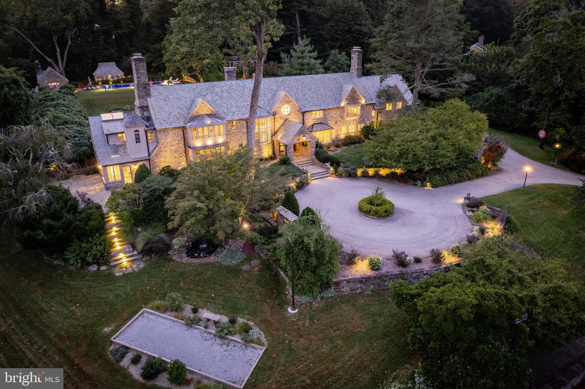 This is it! Look no further and enjoy this rare Main Line gem, combining all of the spectacular interior and exterior architectural features and materials of the 1930's with exquisitely executed renovations and improvements throughout. Enter through the stately gates and continue up the beautifully designed winding driveway with gloriously landscaped grounds into the welcoming courtyard. This breathtaking setting offers endless wrap around terraces, a beautiful pool, pool house with bath and sauna, outdoor kitchen building with fireplace, lit tennis court, bocce court and separate gym facility, all within the completely private and peaceful grounds. The sun-filled interior with elevator access to all levels, offers a grand open foyer with high ceilings, open access to the spacious and bright living and dining rooms, fabulously renovated white gourmet kitchen with large working/ eat-in island, top of the line appliances, large pantry closet, breakfast room and opening up to the incredible two story family room with 3 walls of windows looking out to the incredible grounds. Two staircases access the spacious second floor which offers a sophisticatedly renovated Master Suite with designer bath, 5 additional bedrooms all with renovated en-suite baths, and a large laundry room. The clean, dry lower level includes walk-out access, a newly renovated full bathroom, wine room, media room and lots of storage. Close to renowned Lower Merion and private schools, wonderful clubs, all modes of transportation, Philadelphia International Airport and more. Move right in!!