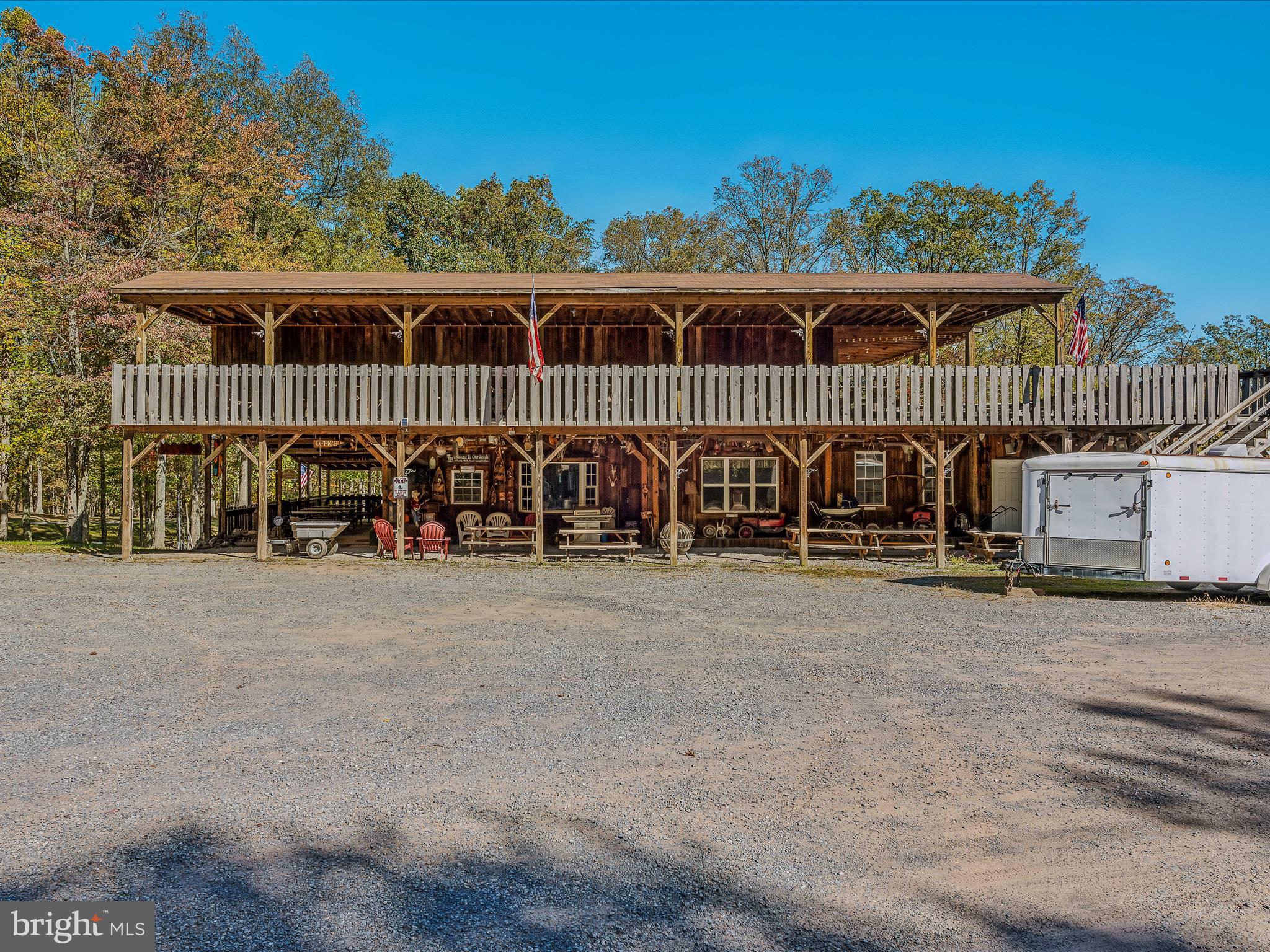 Nearly 56 acres with plenty of spaces for camping and trails throughout. There are several cabins on the property and even a common area space. Property lends itself to seller living in the main cabin and friends or family living in the other cabins. There is the potential for renting the cabins or the camping sites already set up or perhaps you want to expand on this potential as an active productive campground. Currently sellers rent some of the cabins and camping sites but have chosen not to expand on this potential. 2 ponds and even an area that is fenced for chickens or goats. Beautiful view for all the seasons. Lots of possibilities with this one! Just waiting for you to write the next chapter.