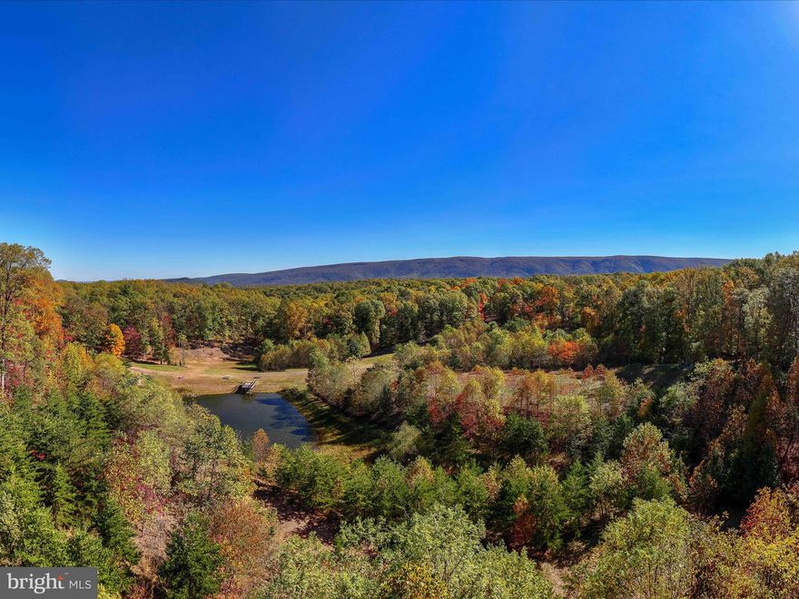 56.14 acres of mixed wooded and open land offer endless possibilities, from living on the property to renting out cabins, buildings, and multiple campsites. Many sites are equipped with electricity and hookups for water and sewer, while others are primitive. There is street lighting throughout. The main building, called The Lodge, currently serves as a common area for all the cabins but it  could be the main house. It features heat and air, cozy woodstove,  bathrooms, laundry, showers, a game room with pool table, a library, and a private kitchen for owners. The Lodge's upper deck includes a beautiful area for entertaining or watching the sunrise with your morning coffee .  The property boasts approximately 3.1 miles of trails for hiking or ATVs, two ponds, and a pavilion with electricity, water, and nearby bathrooms. There is also a fenced area that once served as a small petting zoo. With so much potential, this property is ready for its next chapter. Locked gate—no drive-bys.