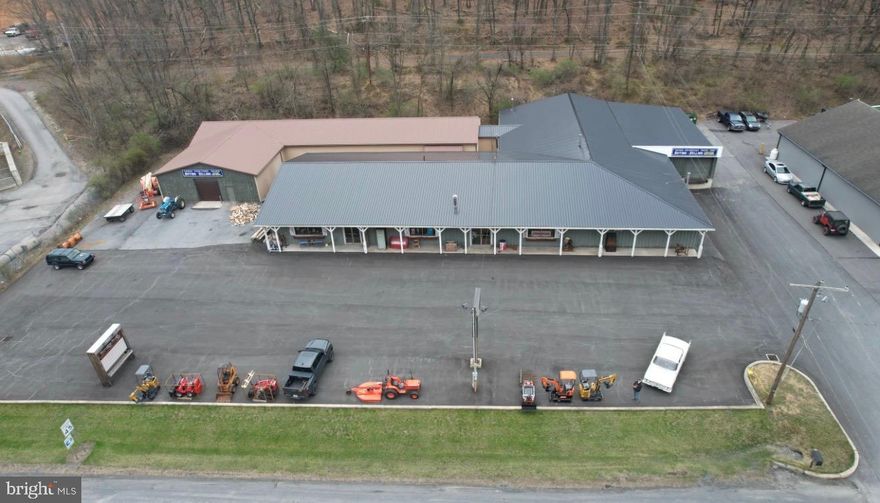 This 1.3-acre +/- Commercial property is right on heavily travelled Rt. 309 in a highly developed area that boasts a lot of road frontage. There is ample parking to accommodate your business in this 15000 sqft (+/-) facility.  The storefront is approx. 6600 Sqft and the warehouse/shop is approx. 8600 sqft.  There are 2 large garage doors at grade at either end of the shop/warehouse for easy in and out with vehicles/forklifts etc. There is also a sliding door that allows vehicles/power sport, equipment or store items to be brought right in from the shop/warehouse without exiting the building.  The showroom has a new efficient hanging propane heater. There are two double commercial doors in front to allow a high flow of customers as well as wider merchandise to be brought in. Included with the sale is an exceptional amount of pallet style racking. The new metal roof, fresh paved parking lot, loading dock (with leveler make this a very attractive, low maintenance and versatile commercial facility. There is an option for a triple net lease also, contact agent