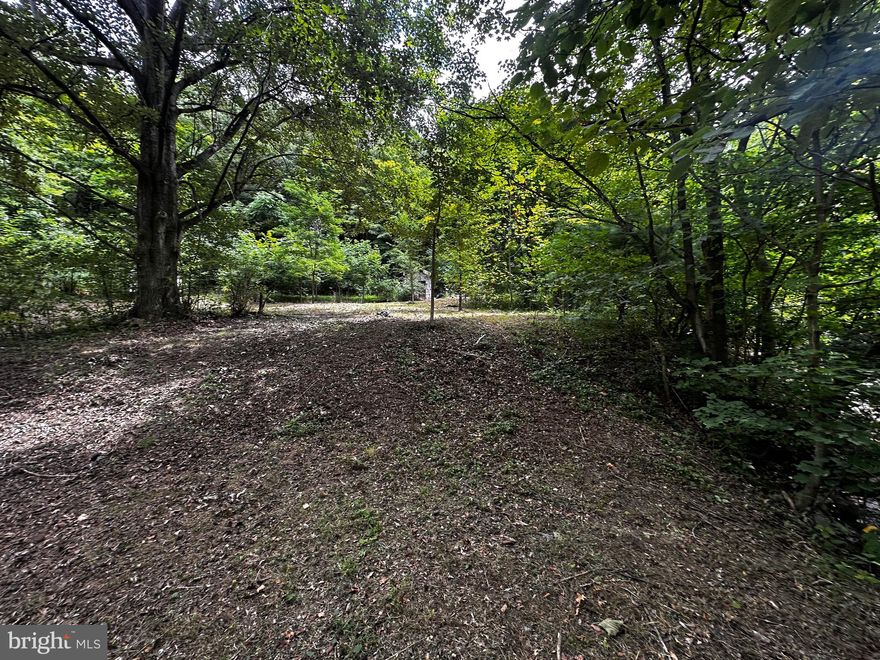 ONLY MINUTES FROM TOWN.  2.01 ACRES OF UNRESTRICTED LAND WITH UTILITIES AT SITE.  LEVEL TO GENTLY ROLLING TOPOGRAPHY.  (3) BARN STYLE SHEDS CONVEY WITH SALE.  SEVERAL BUILDING SITES ON PROPERTY. STEAM ON FRONT OF PROPERTY.  DIRECT ACCESS OFF U.S. RTE #50 OVER BRIDGE (PRIVATE).  PRIVATE OUT OF TOWN LOCATION TO BUILDING THAT NEW HOME. CALL  FOR SHOWING, YOU WON’T REGRET IT.